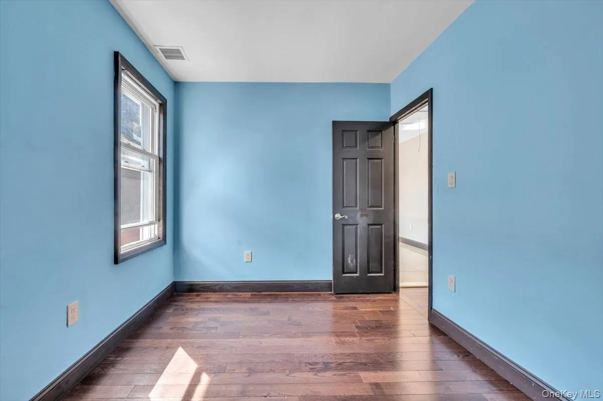 Unfurnished bedroom featuring baseboards and dark wood-style floors Unfurnished bedroom featuring baseboards and dark wood-style floors