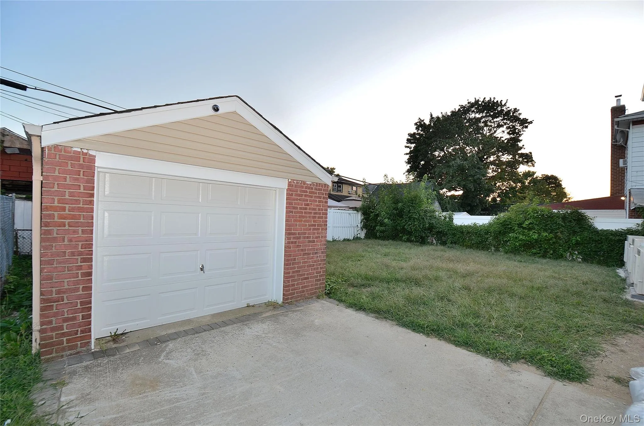 Detached garage featuring driveway Detached garage featuring driveway
