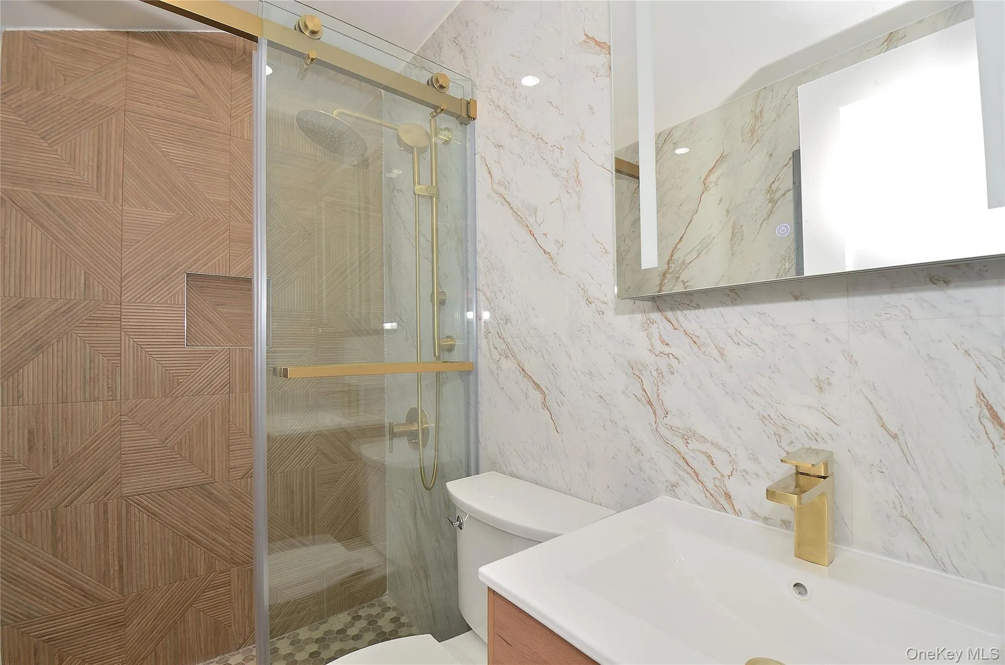 Full bath with a stall shower, vanity, and tile walls Full bath with a stall shower, vanity, and tile walls