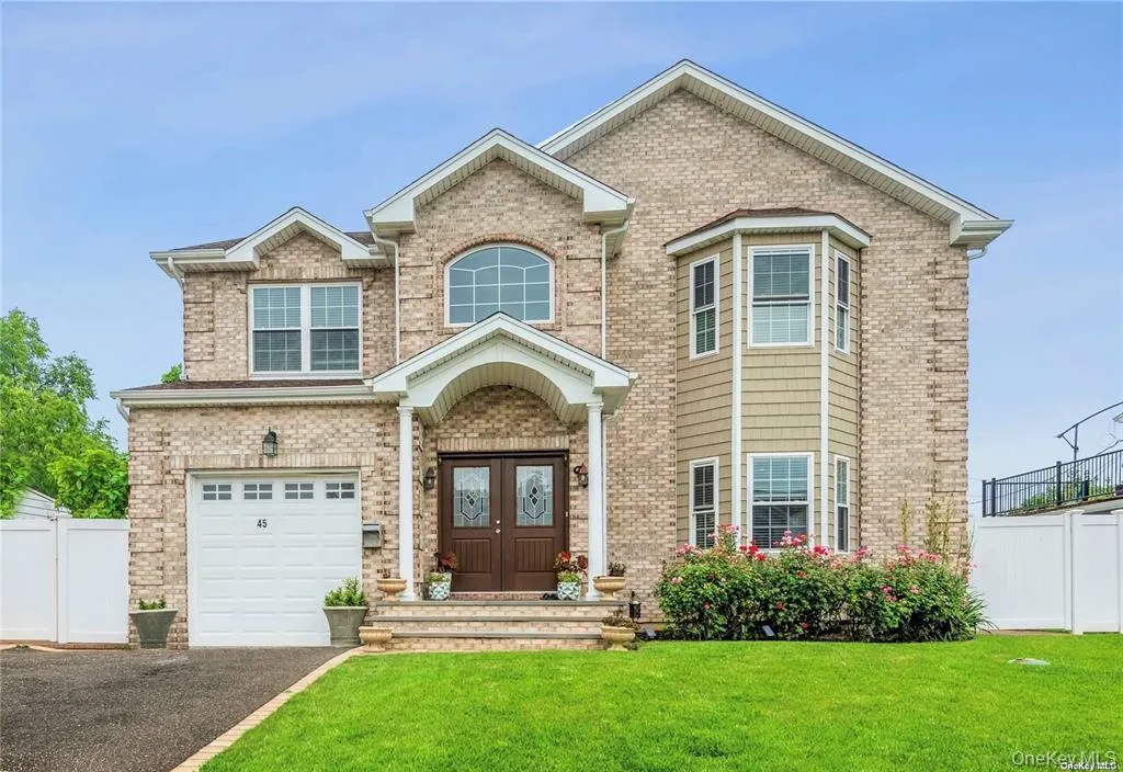 View of front of home featuring a garage, brick siding, and driveway View of front of home featuring a garage, brick siding, and driveway