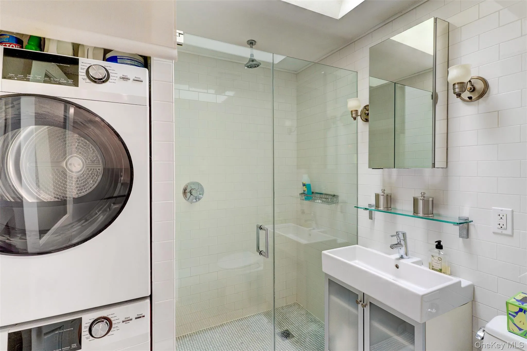 Full bathroom with a stall shower, tile walls, and vanity Full bathroom with a stall shower, tile walls, and vanity