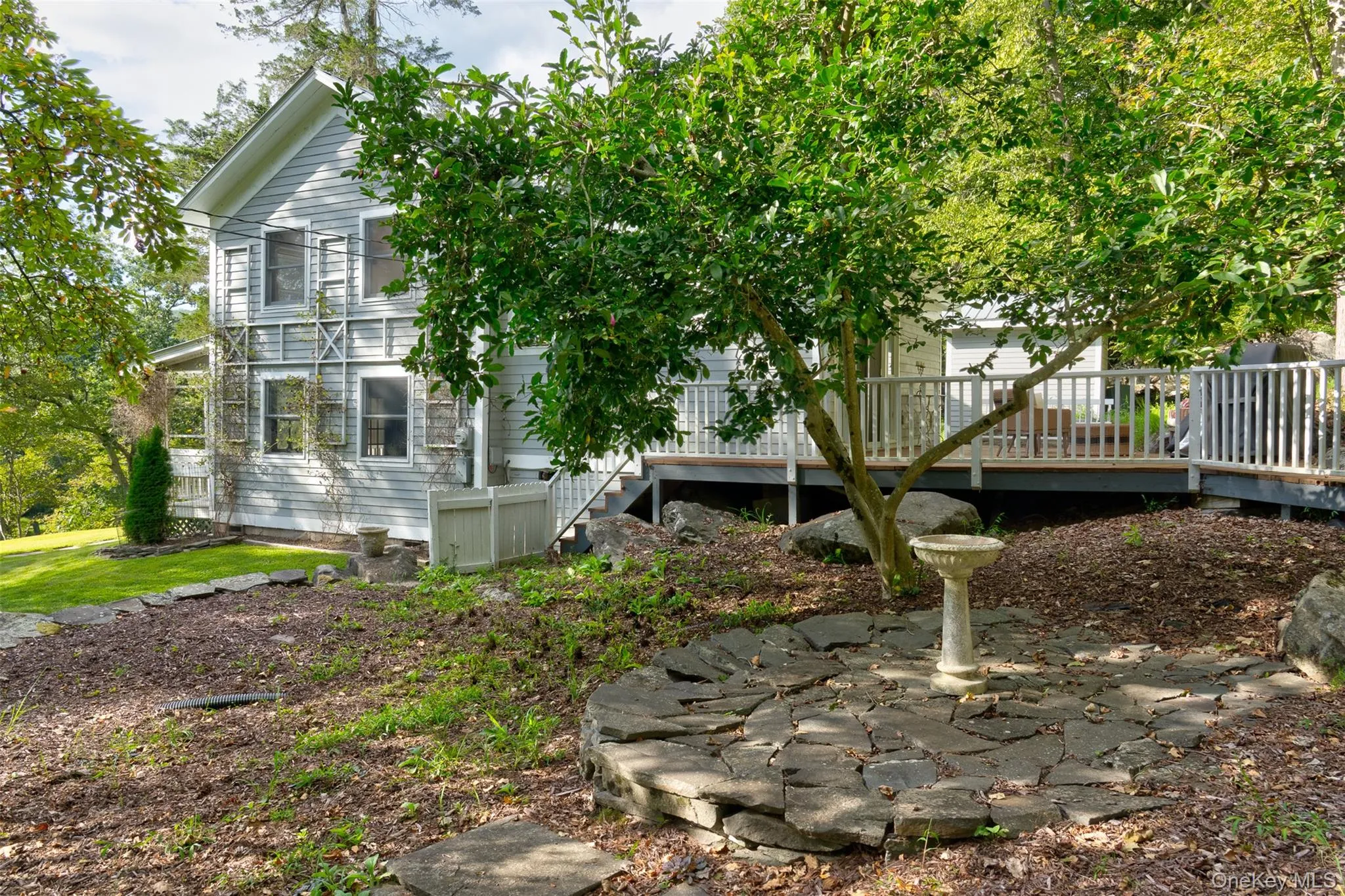 View of side of home featuring a wooden deck and stairs View of side of home featuring a wooden deck and stairs