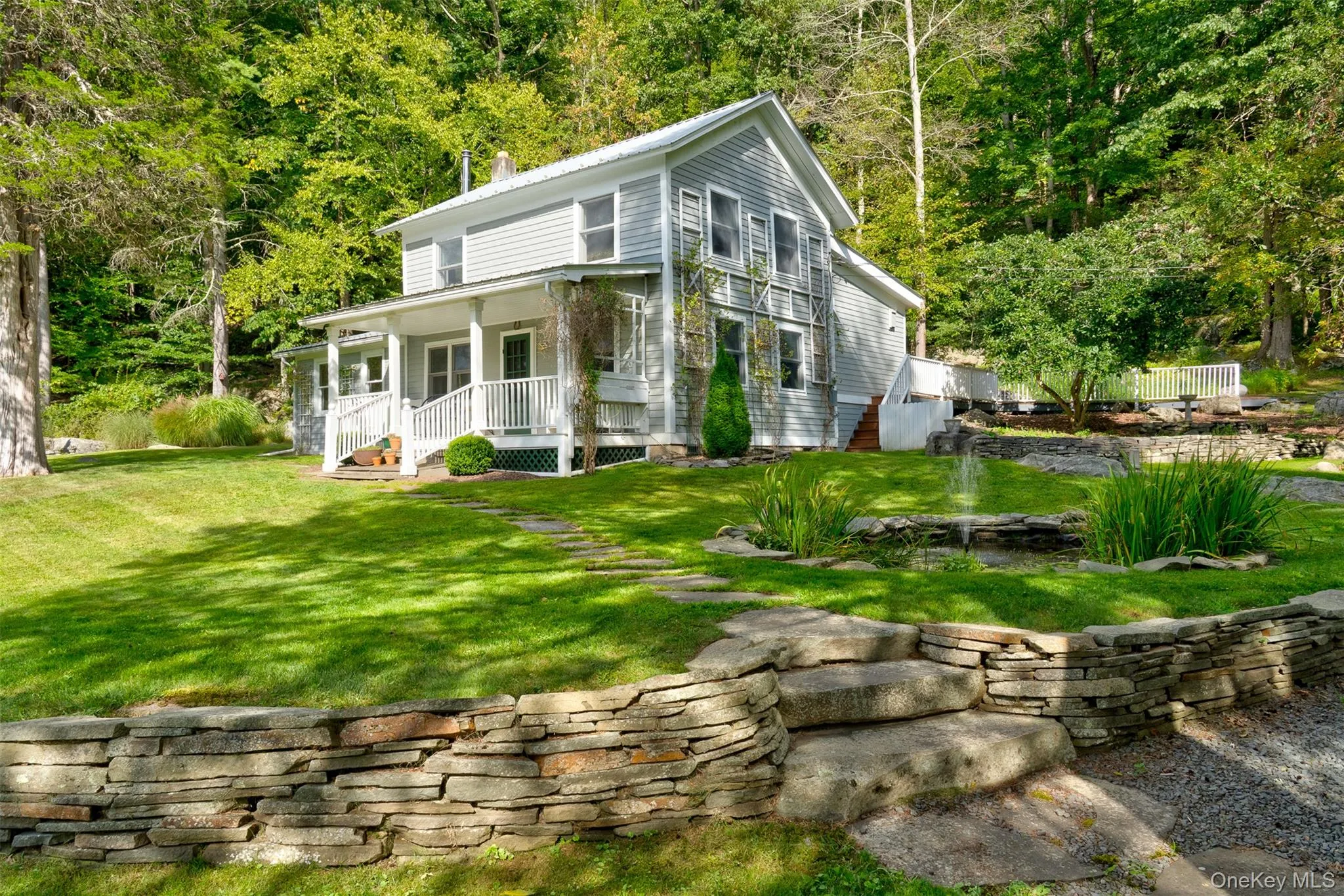 View of front facade featuring covered porch and a front lawn View of front facade featuring covered porch and a front lawn