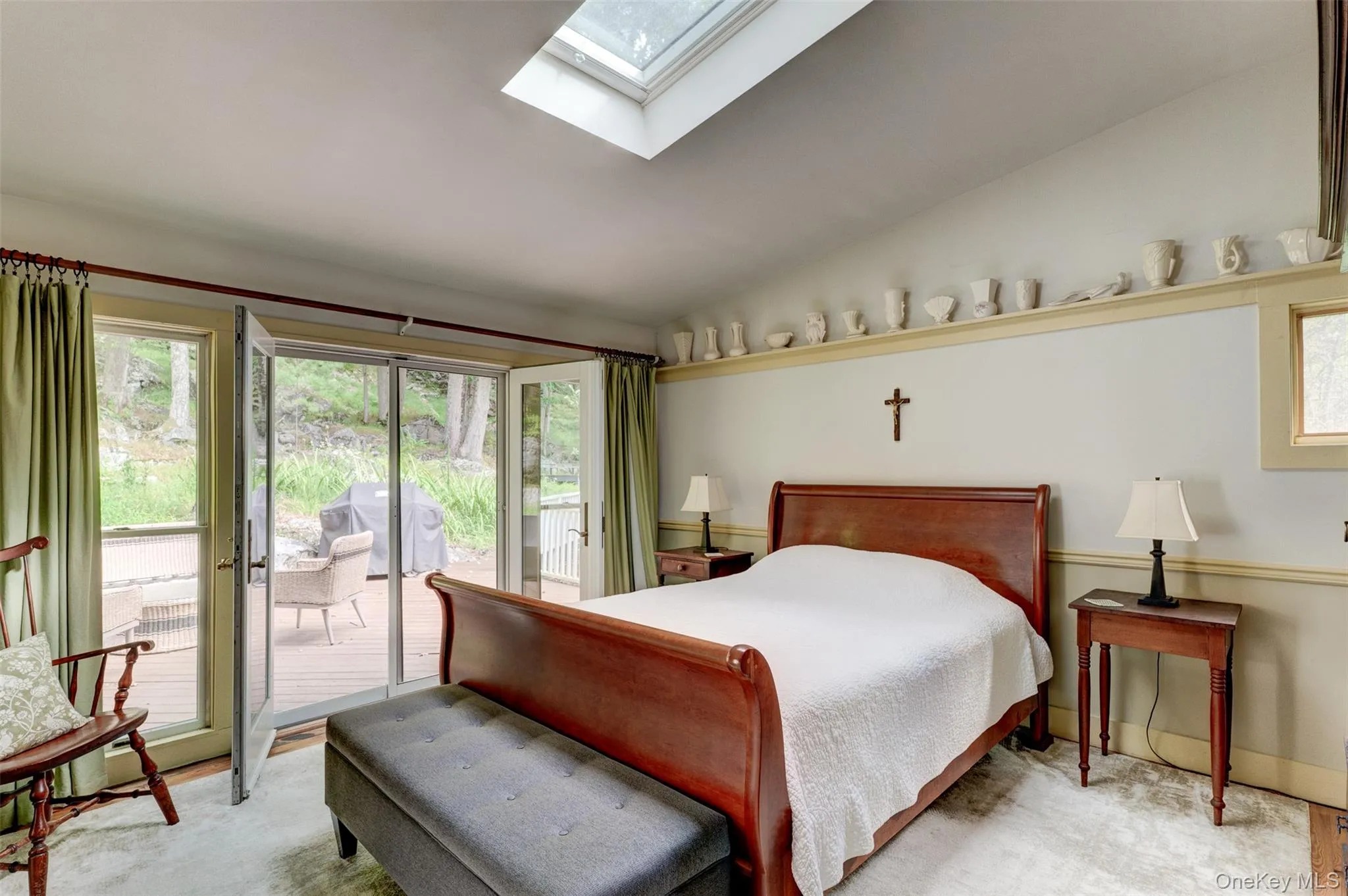Bedroom featuring lofted ceiling, a skylight, and access to outside Bedroom featuring lofted ceiling, a skylight, and access to outside