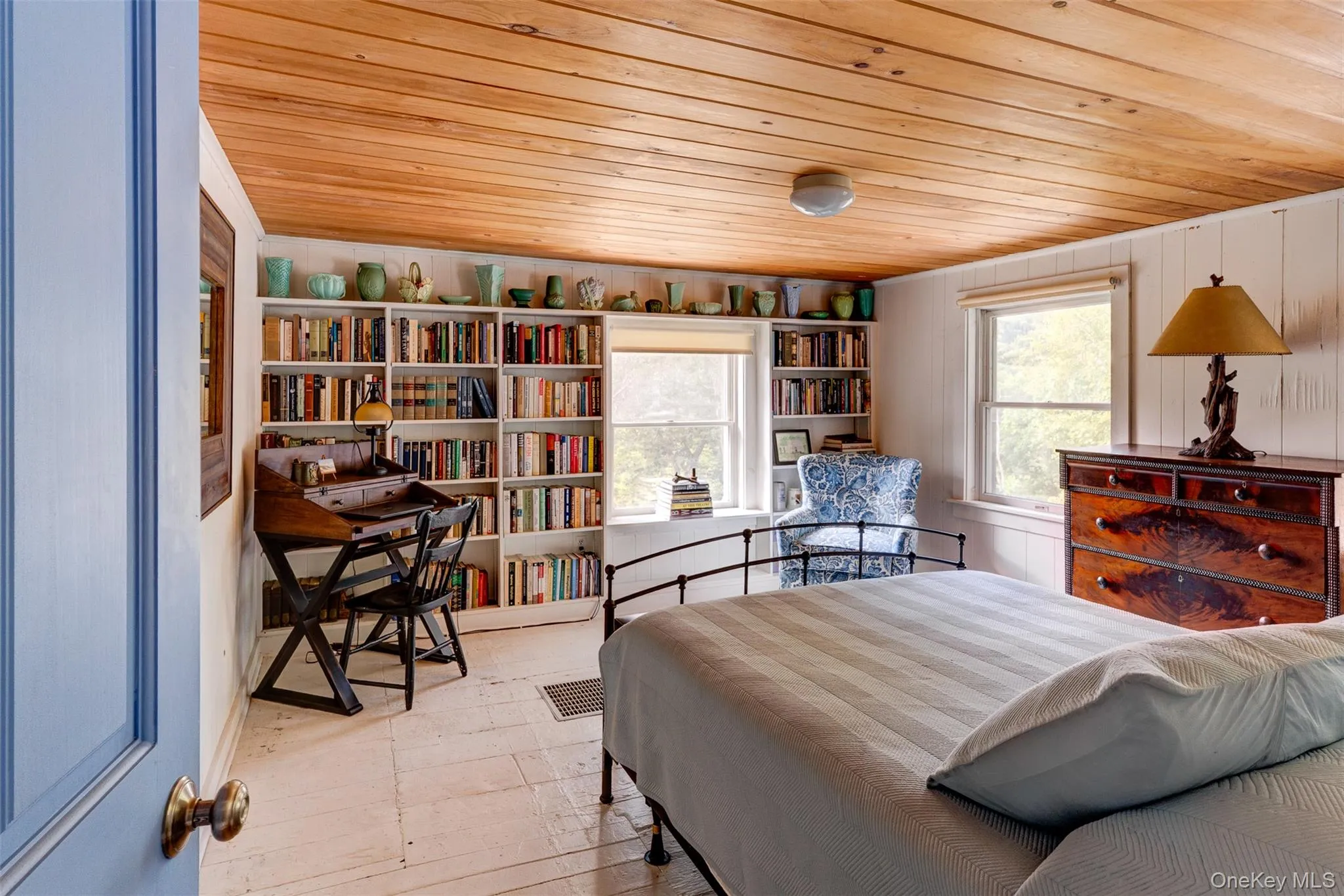 Bedroom with wooden ceiling and wood walls Bedroom with wooden ceiling and wood walls
