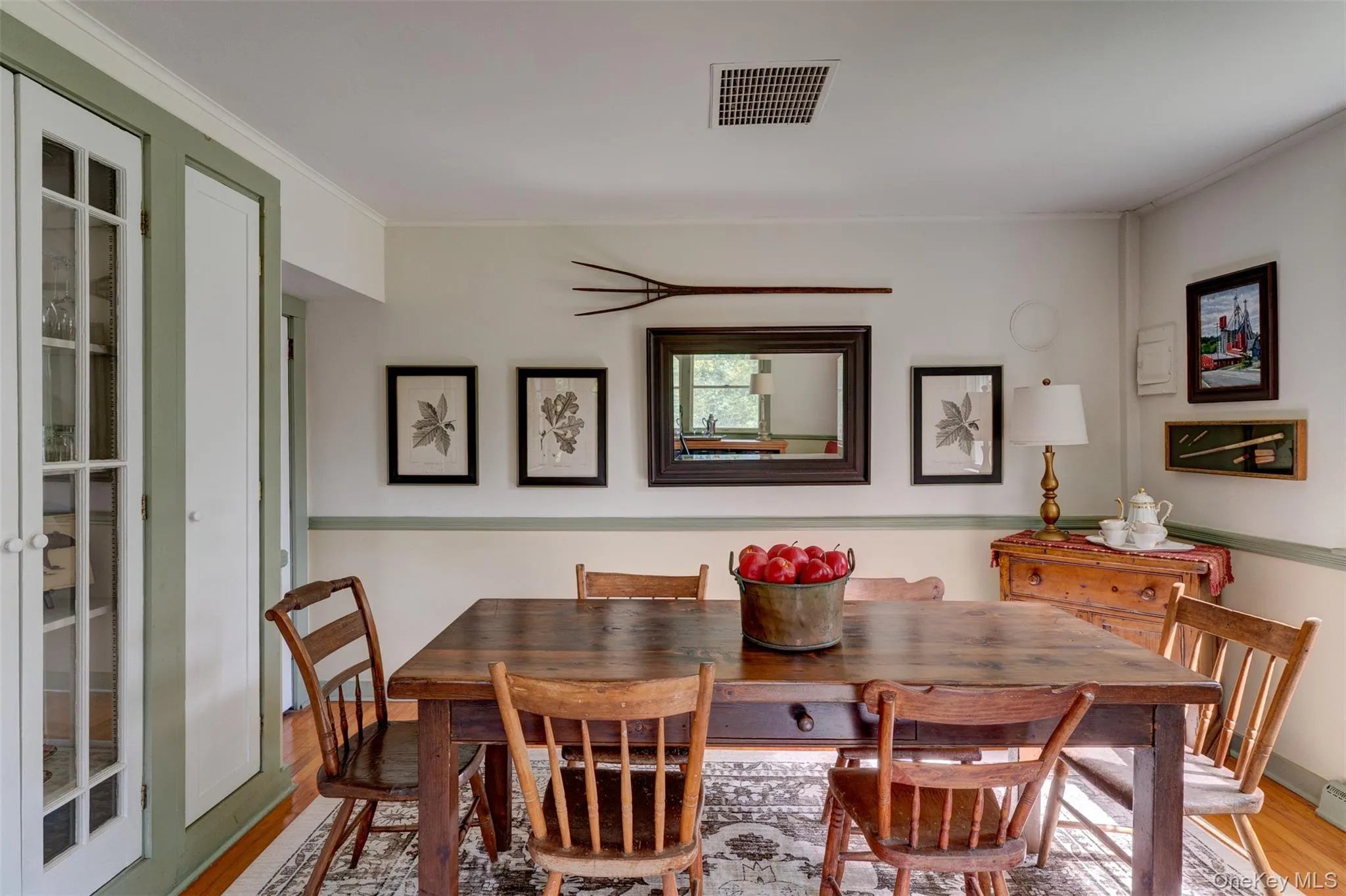 Dining space with wood finished floors and crown molding Dining space with wood finished floors and crown molding