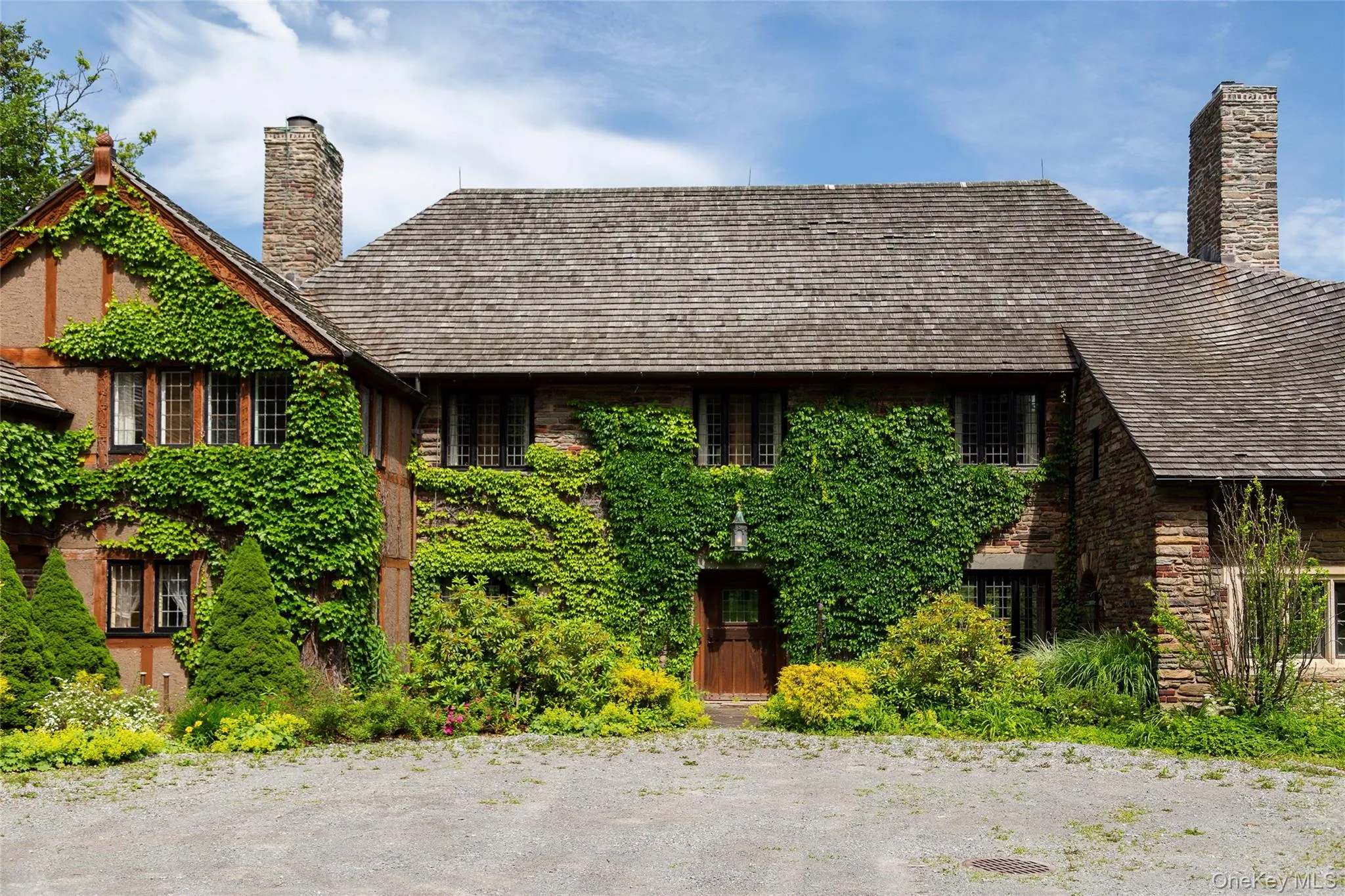 Tudor-style house featuring a chimney Tudor-style house featuring a chimney