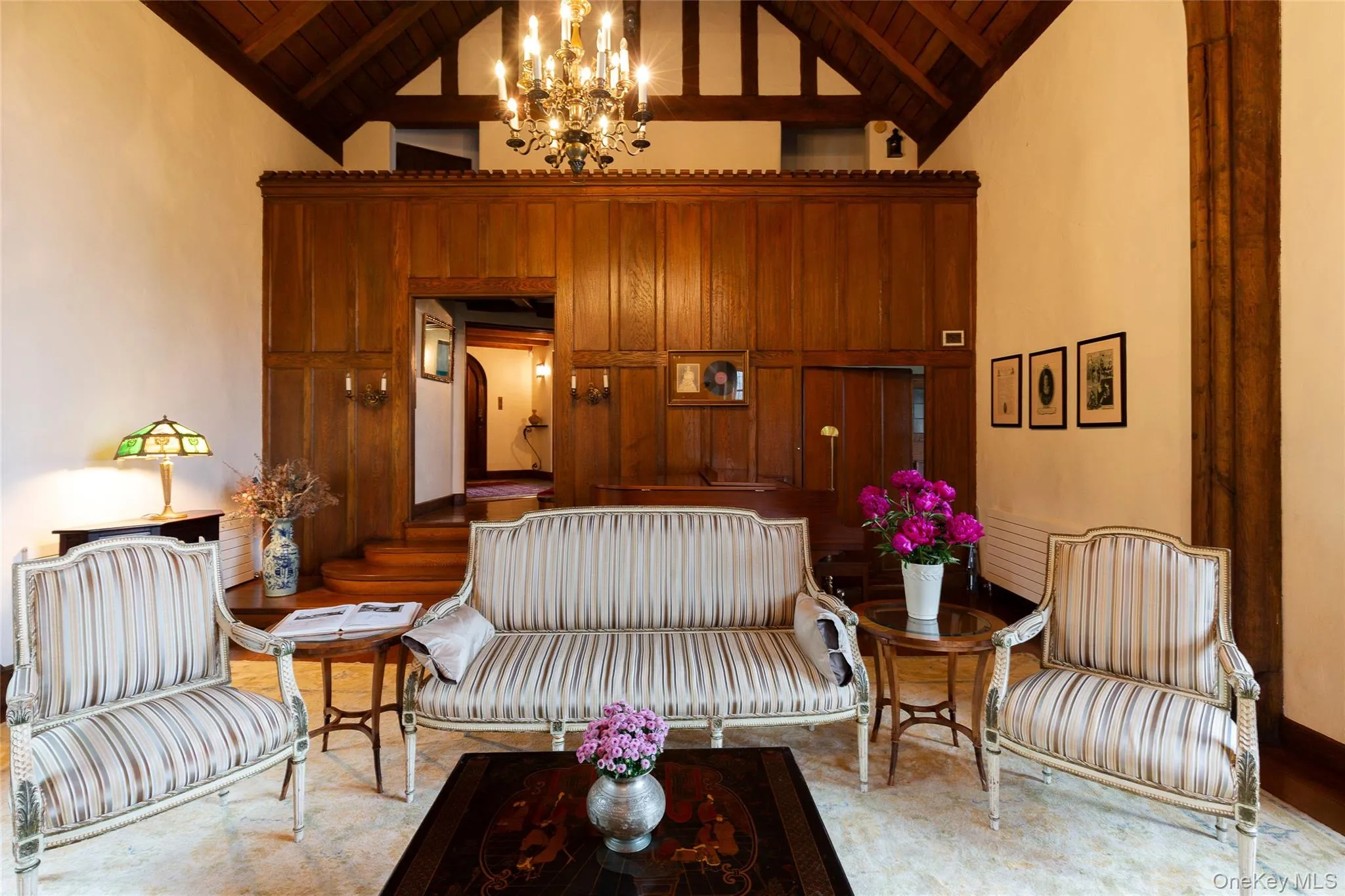 Living area featuring high vaulted ceiling, a wood ceiling with exposed beams, and a chandelier Living area featuring high vaulted ceiling, a wood ceiling with exposed beams, and a chandelier