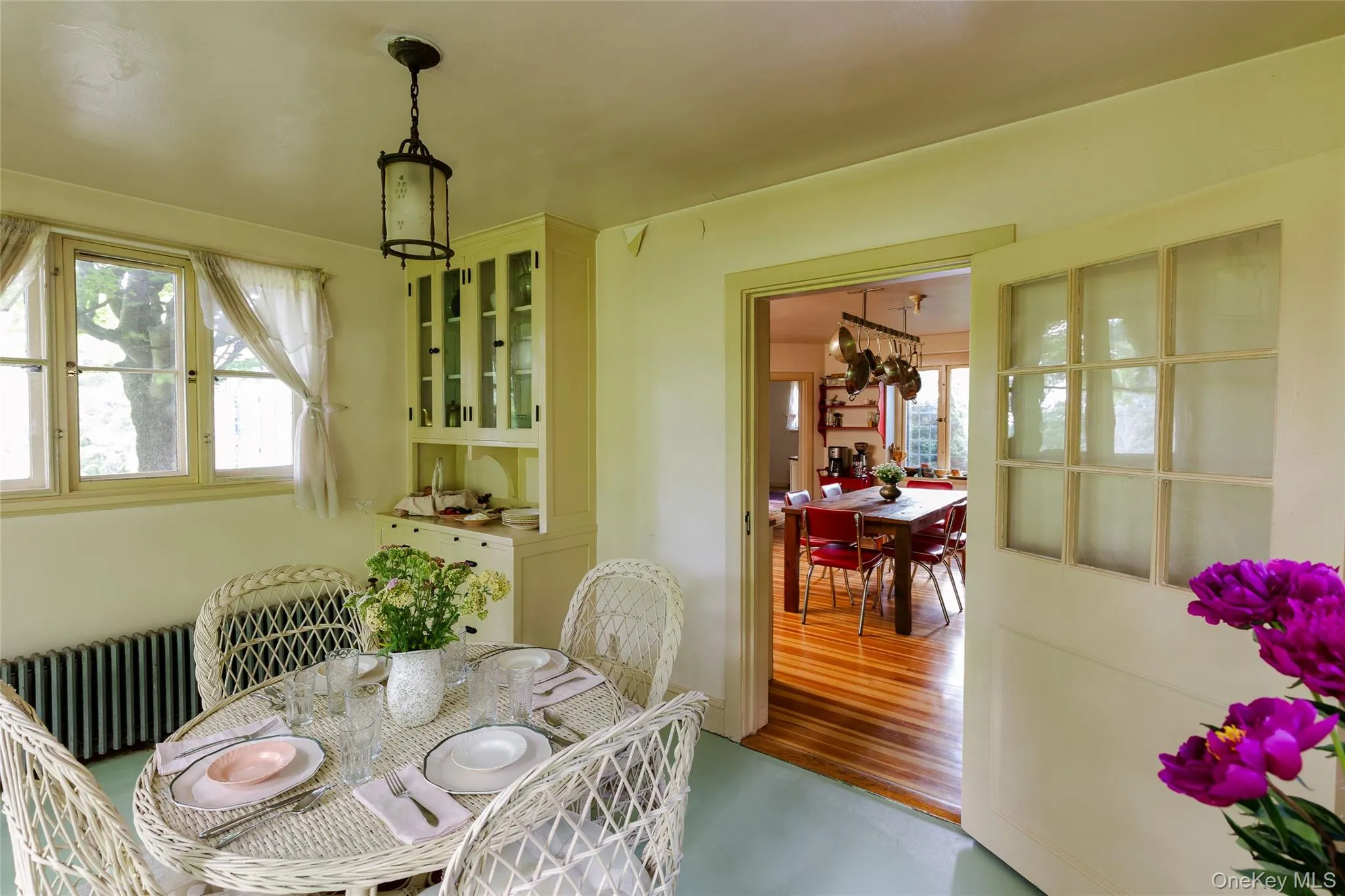 Dining room featuring radiator heating unit and wood finished floors Dining room featuring radiator heating unit and wood finished floors