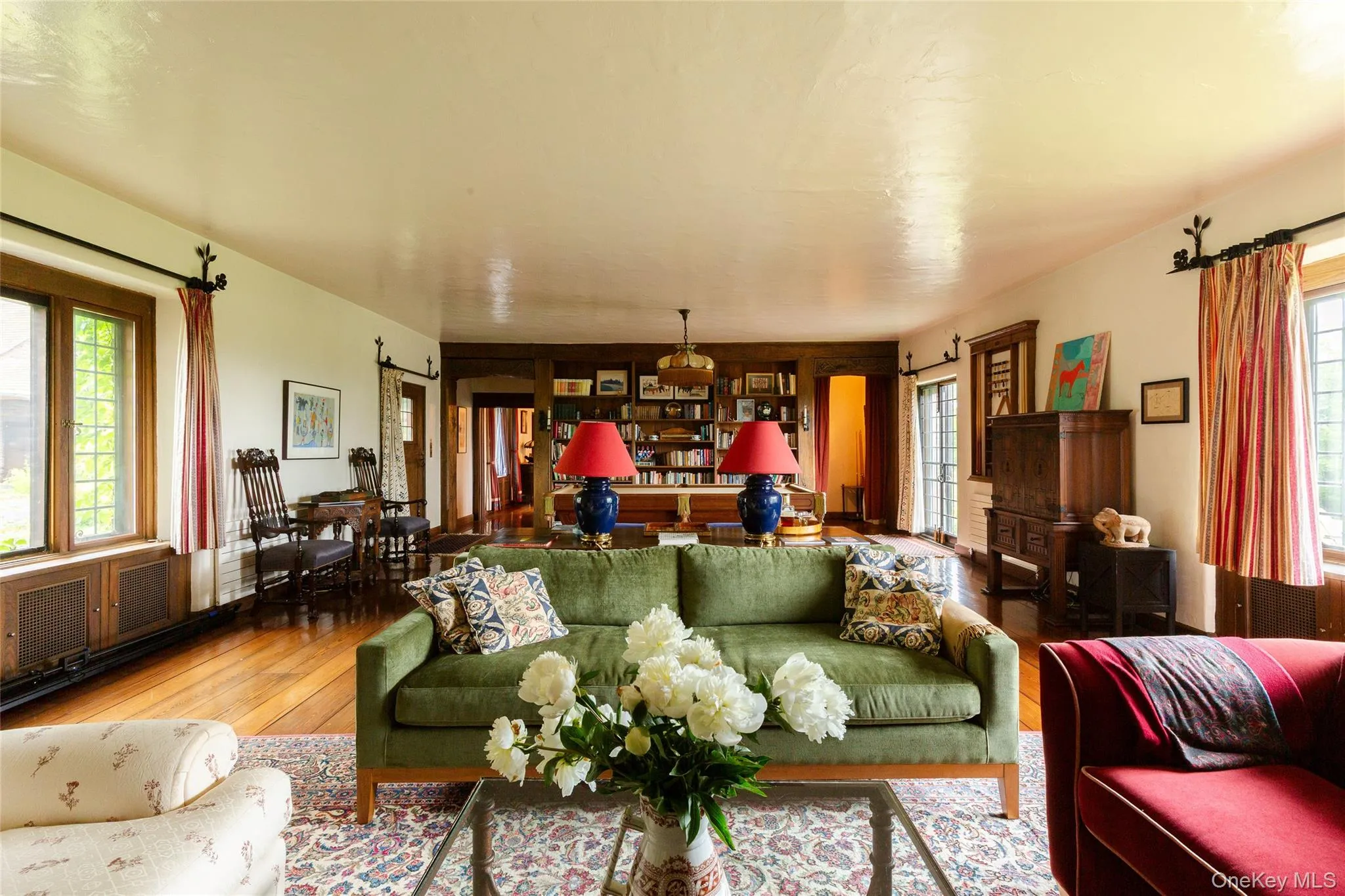 Living area featuring plenty of natural light, hardwood / wood-style flooring, and a barn door Living area featuring plenty of natural light, hardwood / wood-style flooring, and a barn door