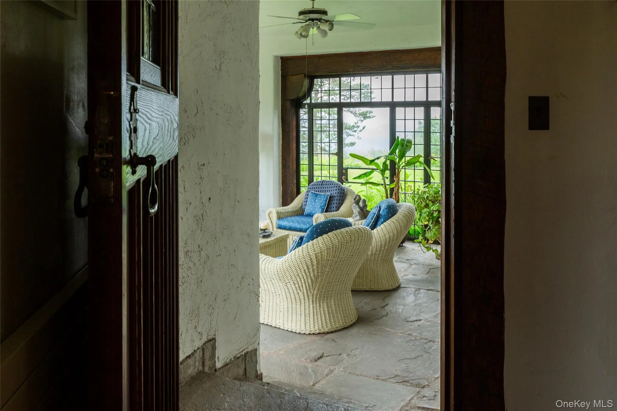 Doorway with stone tile floors and a ceiling fan Doorway with stone tile floors and a ceiling fan
