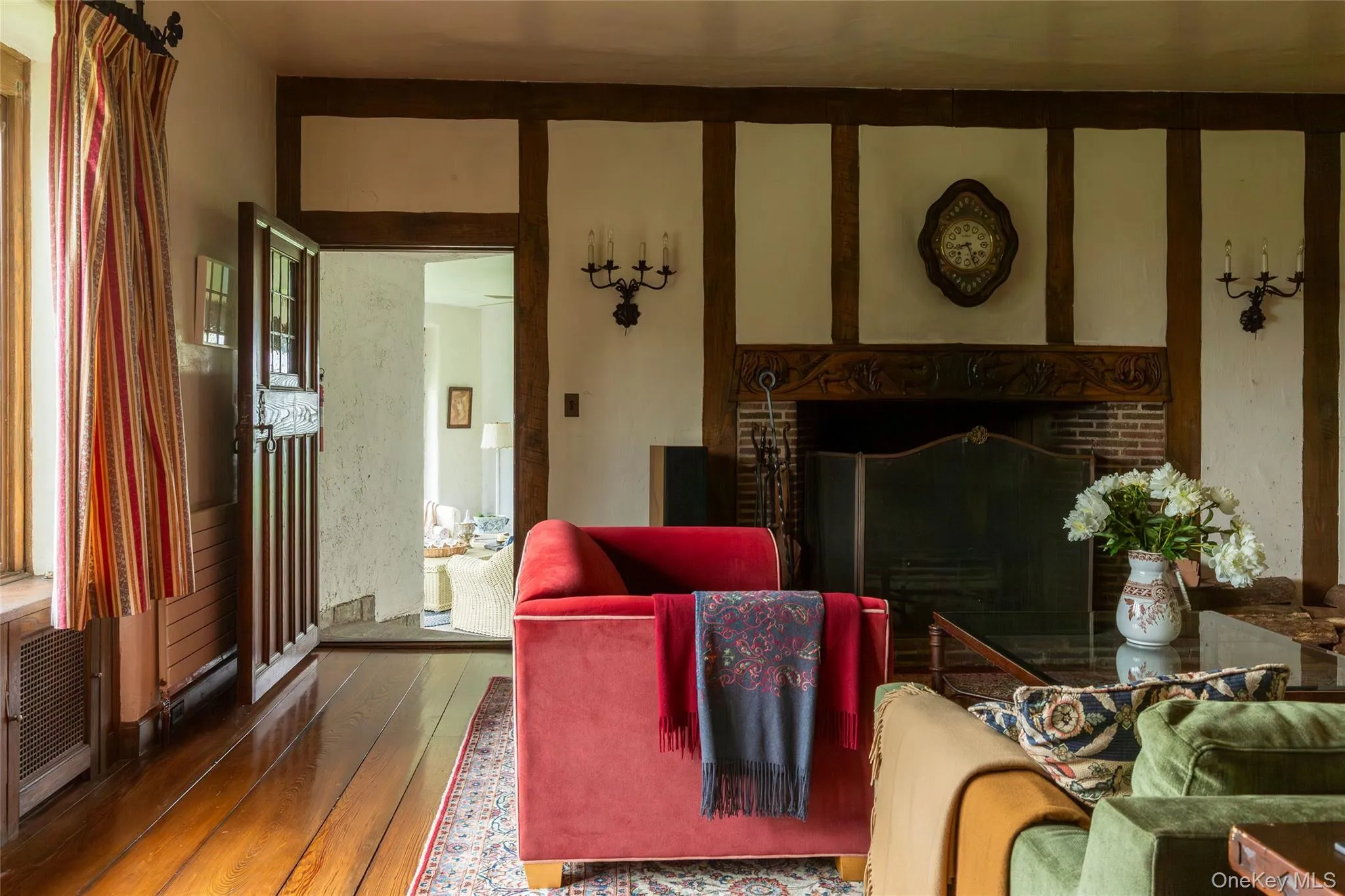 Living room featuring a fireplace and wood-type flooring Living room featuring a fireplace and wood-type flooring