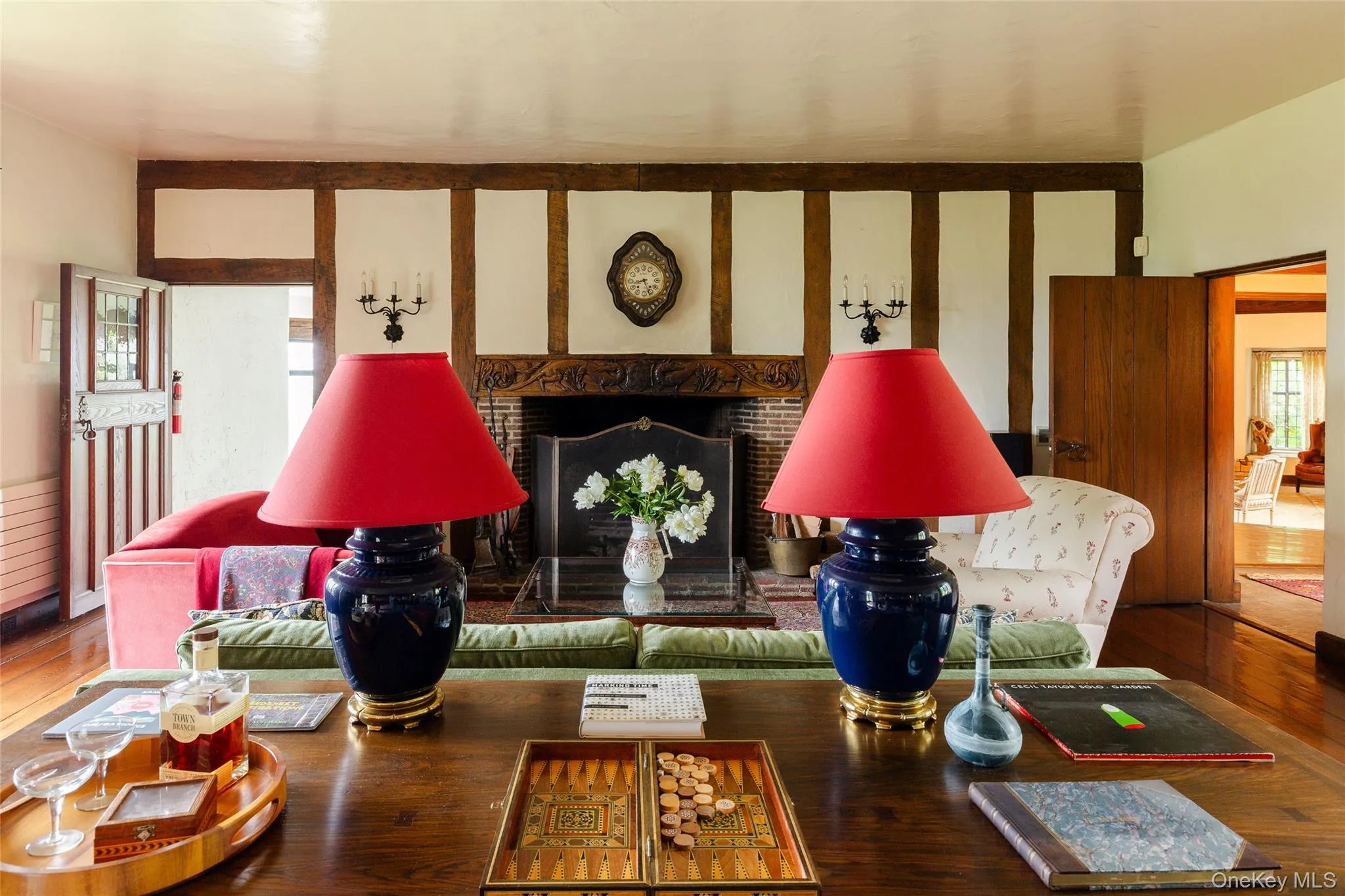 Living room with a fireplace and hardwood / wood-style floors Living room with a fireplace and hardwood / wood-style floors