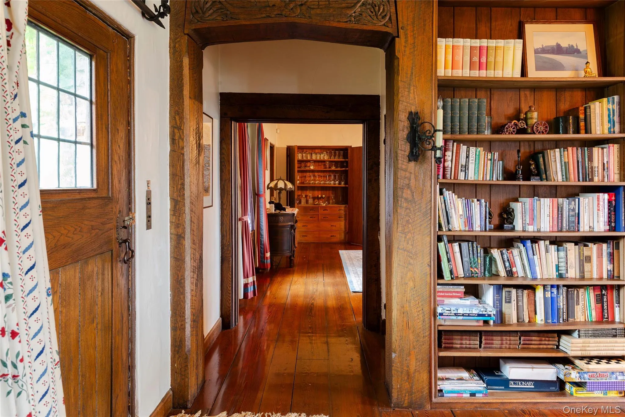 Hallway featuring dark wood-style flooring Hallway featuring dark wood-style flooring