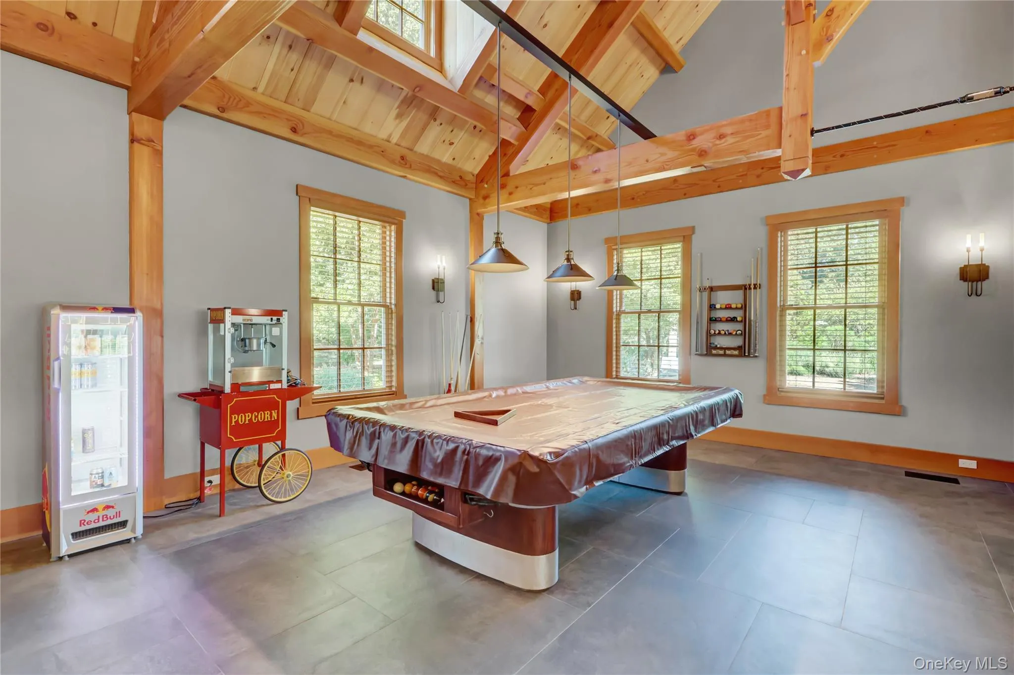 Playroom with billiards, healthy amount of natural light, a wood ceiling with exposed beams, high vaulted ceiling, and a skylight Playroom with billiards, healthy amount of natural light, a wood ceiling with exposed beams, high vaulted ceiling, and a skylight