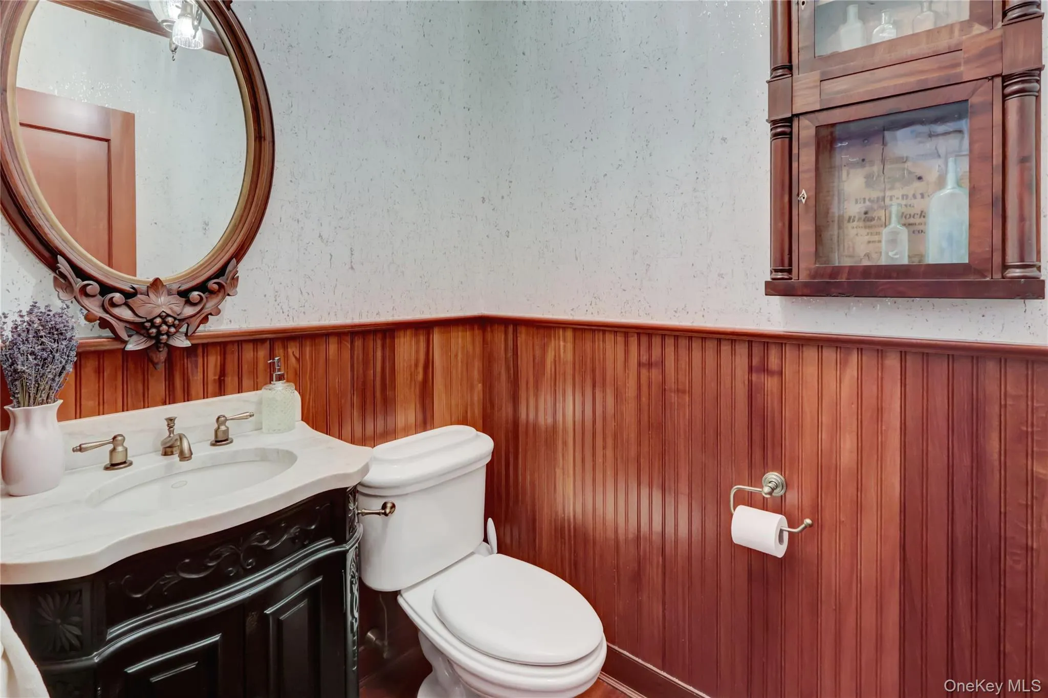 Half bath featuring vanity and a wainscoted wall Half bath featuring vanity and a wainscoted wall