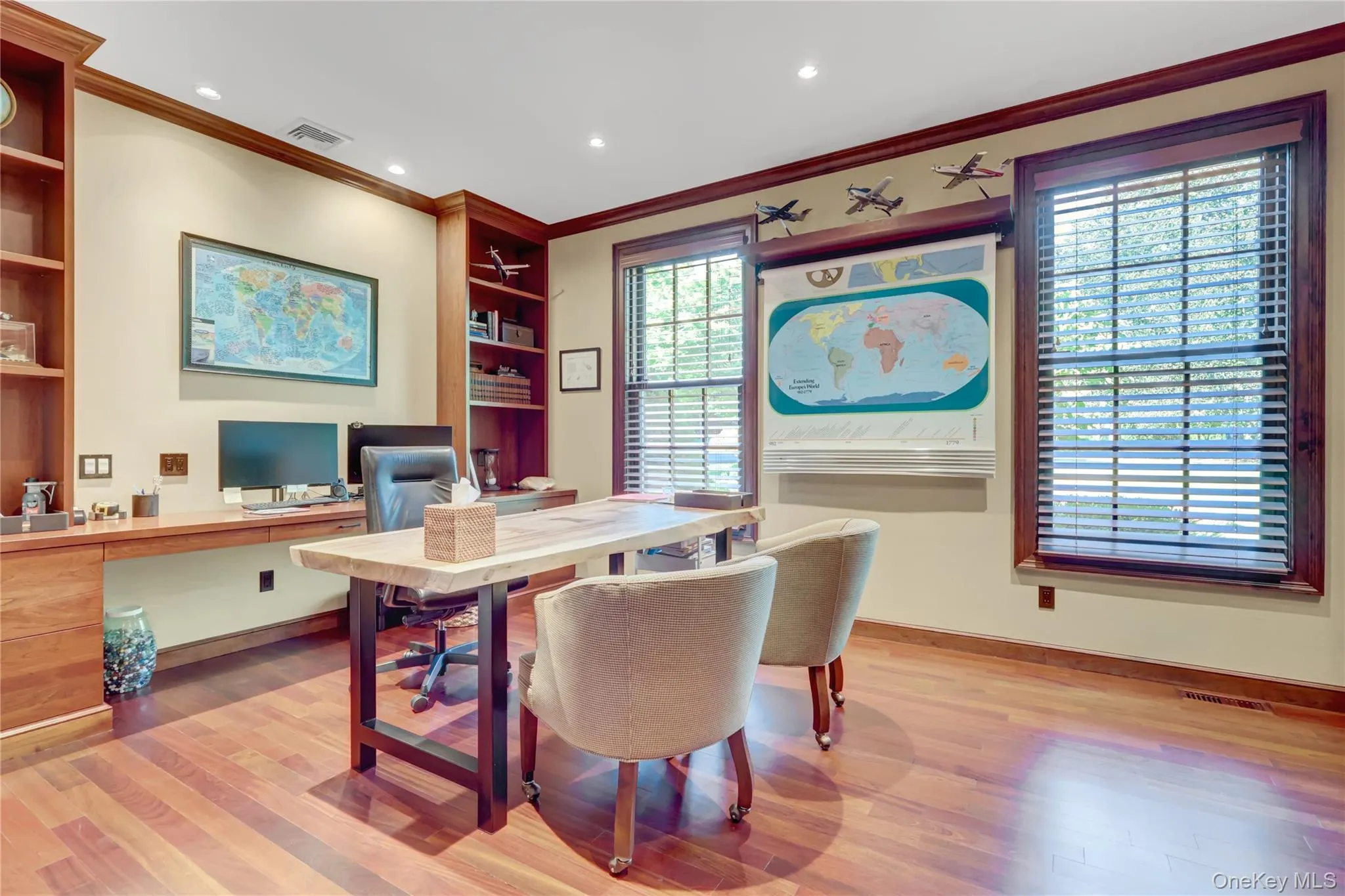 Home office featuring ornamental molding, built in shelves, light wood-type flooring, recessed lighting, and built in study area Home office featuring ornamental molding, built in shelves, light wood-type flooring, recessed lighting, and built in study area