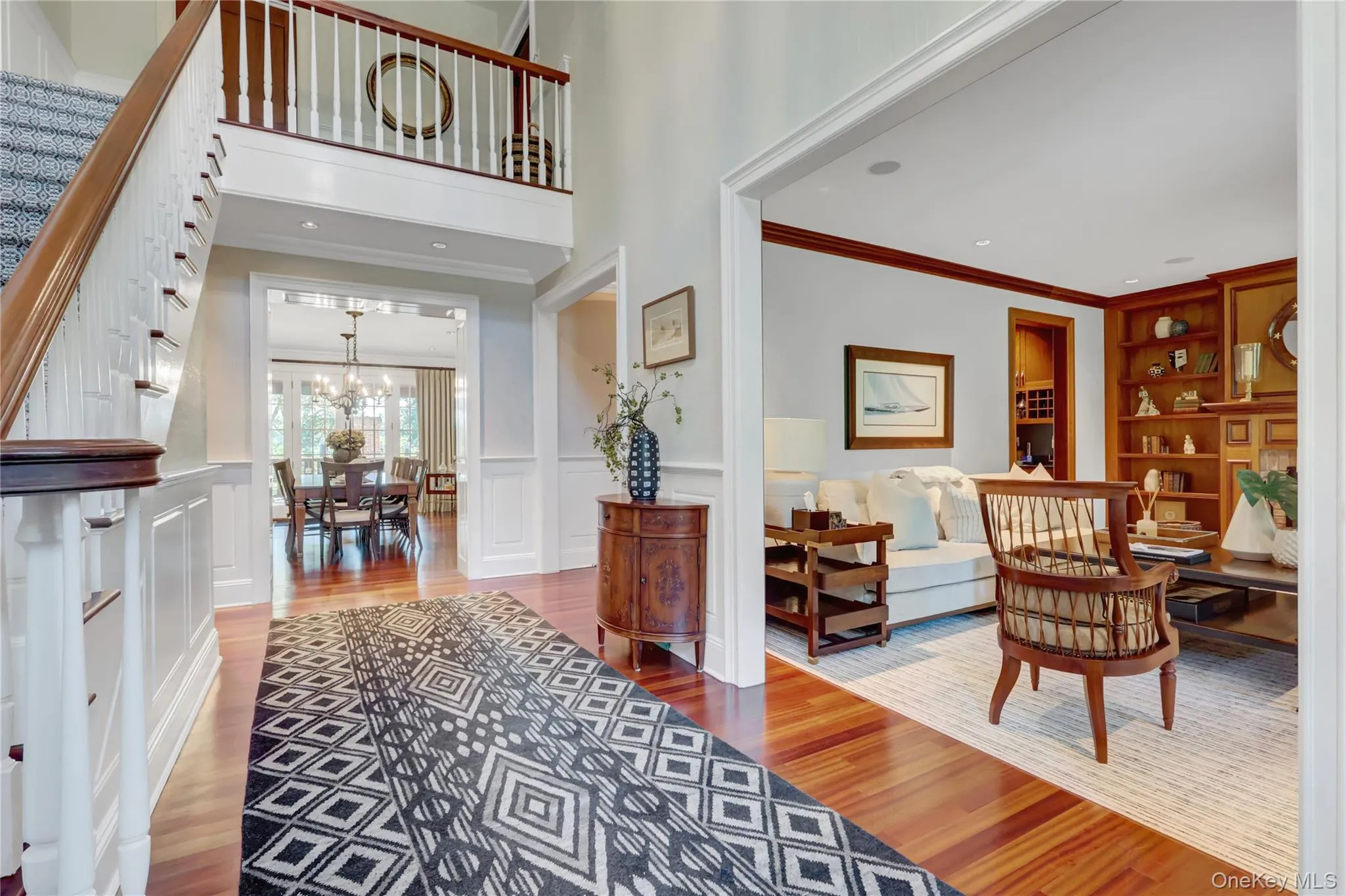 Foyer entrance featuring light wood-type flooring, a wainscoted wall, a decorative wall, crown molding, and recessed lighting Foyer entrance featuring light wood-type flooring, a wainscoted wall, a decorative wall, crown molding, and recessed lighting