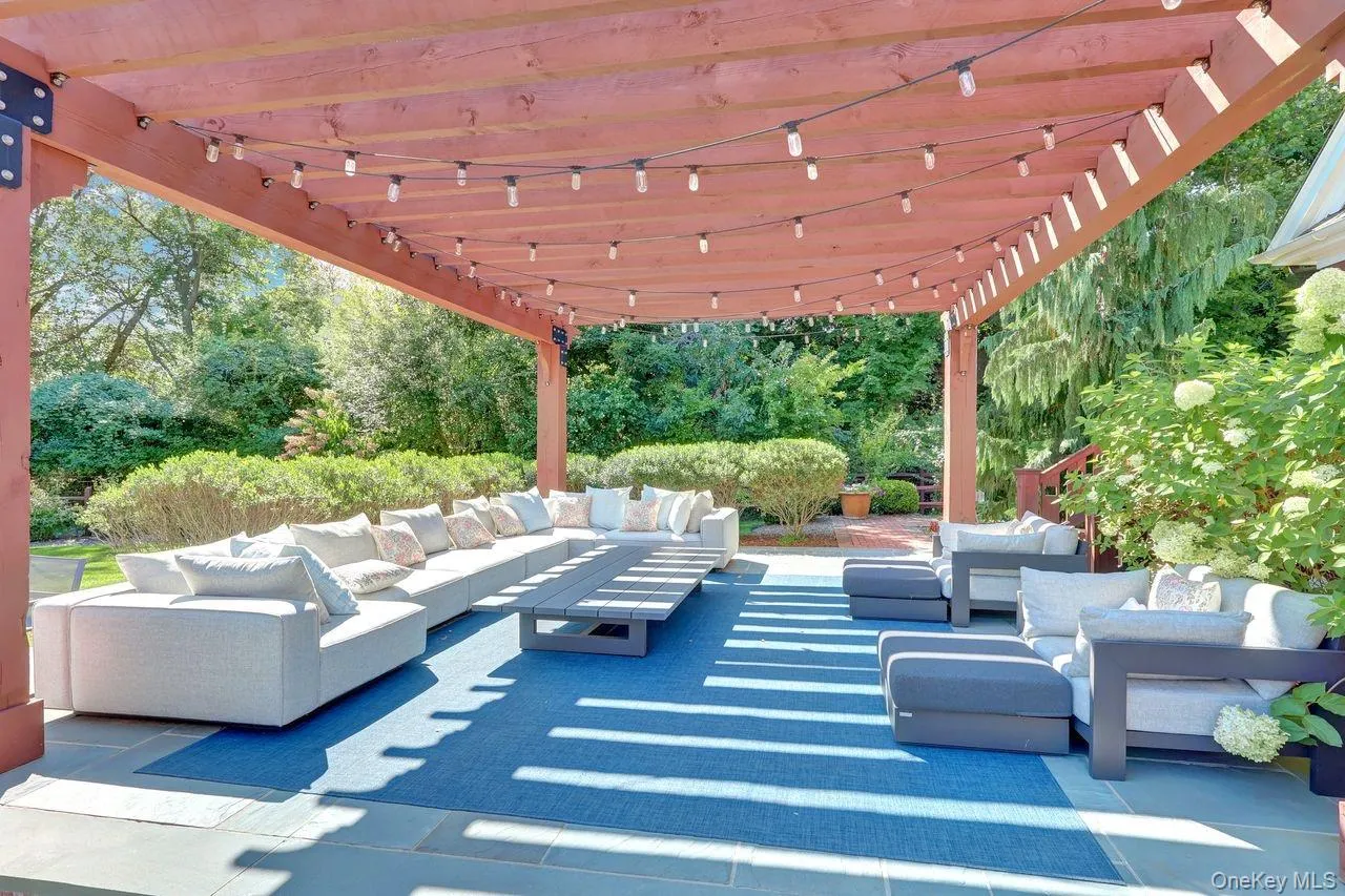 View of patio featuring an outdoor hangout area, a pergola, and view of wooded area View of patio featuring an outdoor hangout area, a pergola, and view of wooded area