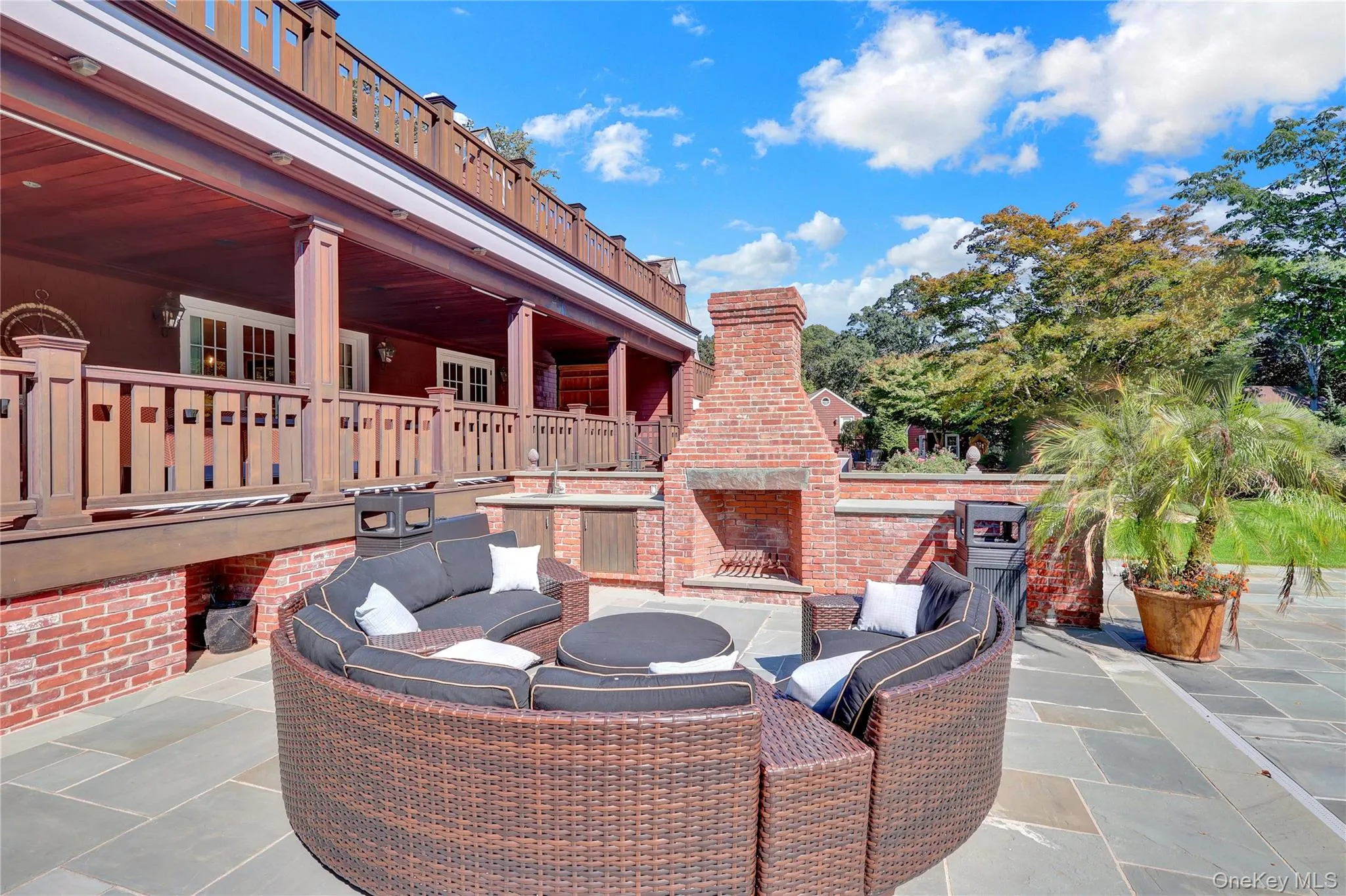 View of patio with an outdoor living space with a fireplace and exterior kitchen View of patio with an outdoor living space with a fireplace and exterior kitchen
