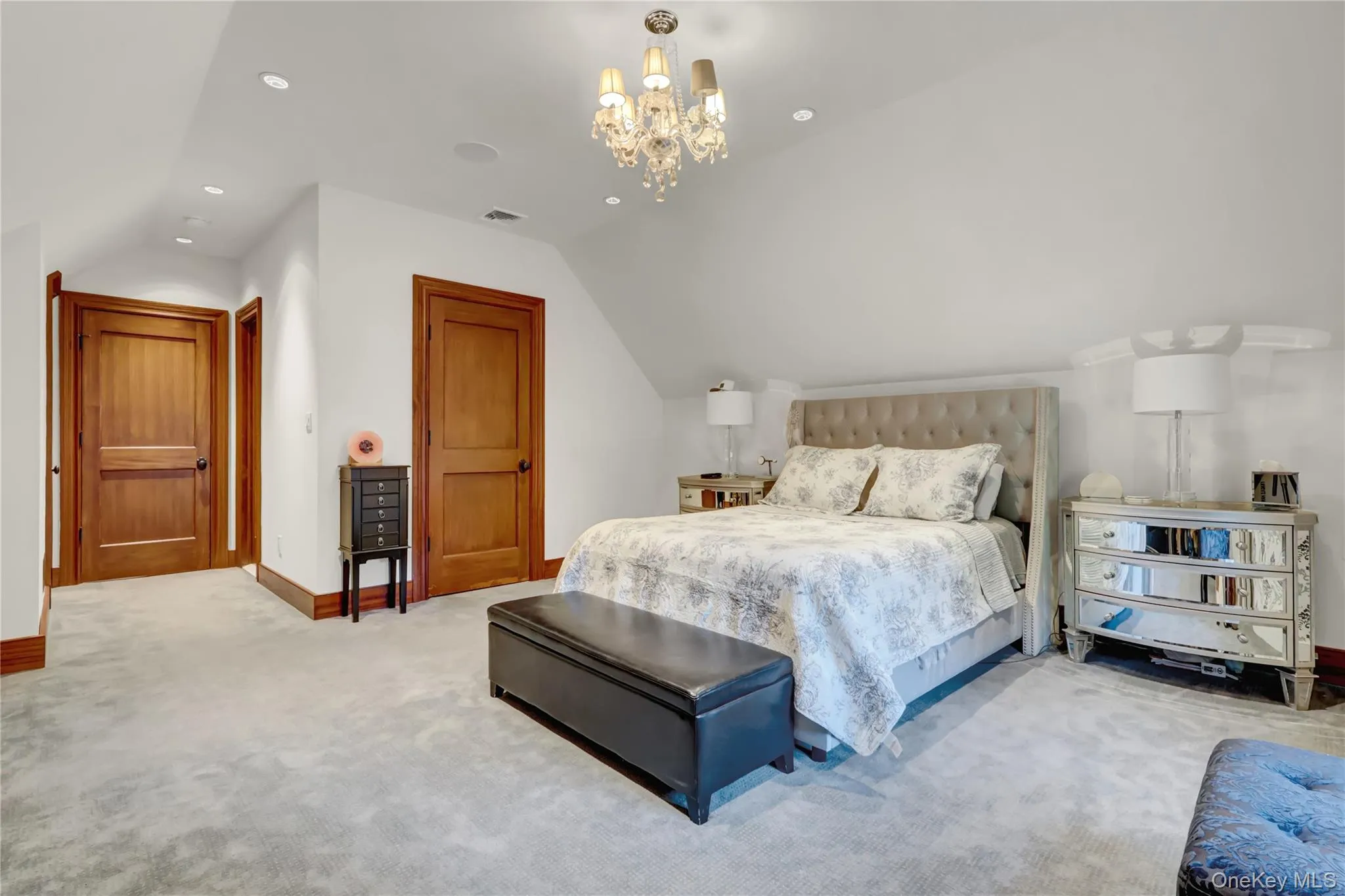 Carpeted bedroom featuring vaulted ceiling, recessed lighting, and a chandelier Carpeted bedroom featuring vaulted ceiling, recessed lighting, and a chandelier
