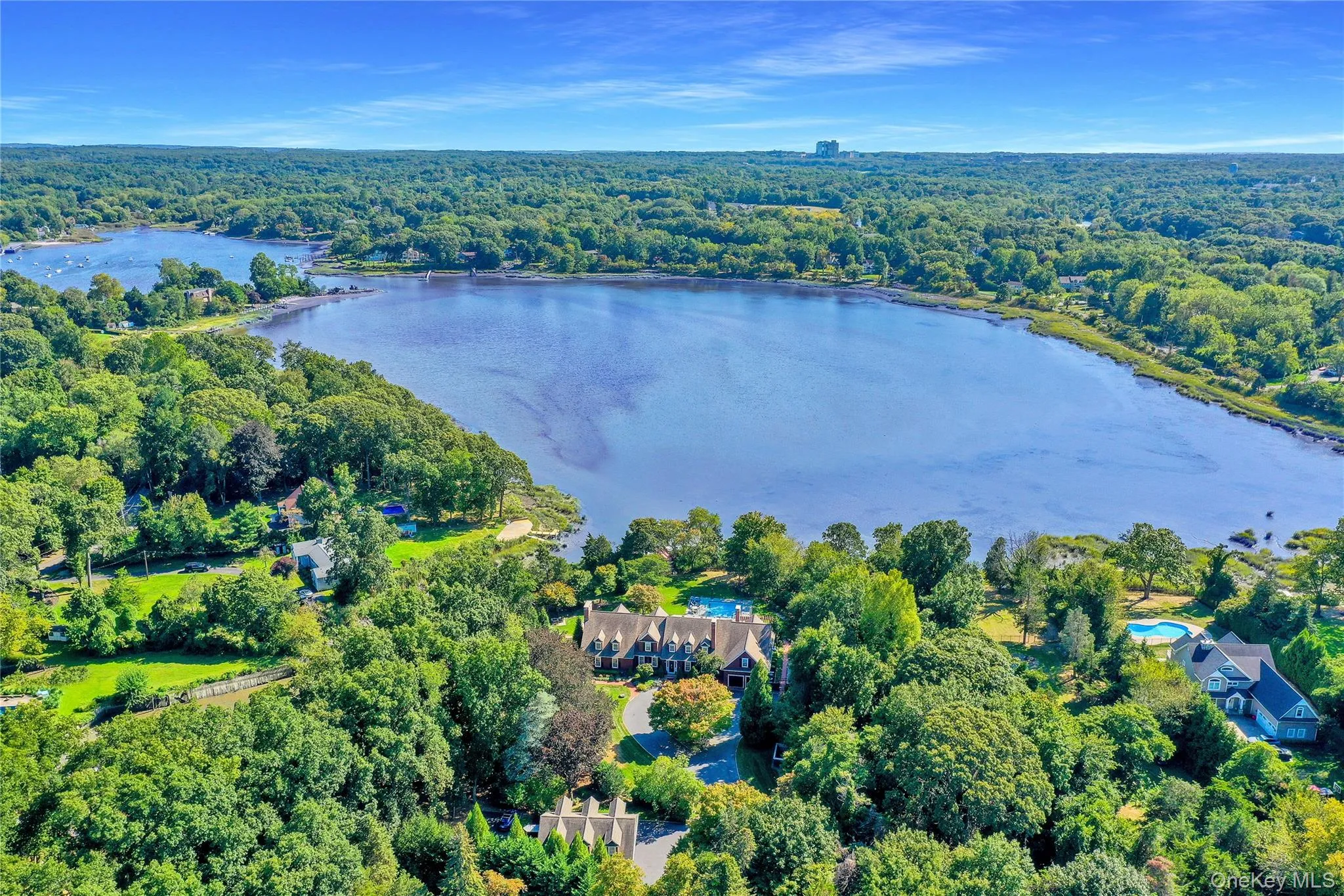 Aerial view of property's location featuring a forest and a nearby body of water Aerial view of property's location featuring a forest and a nearby body of water