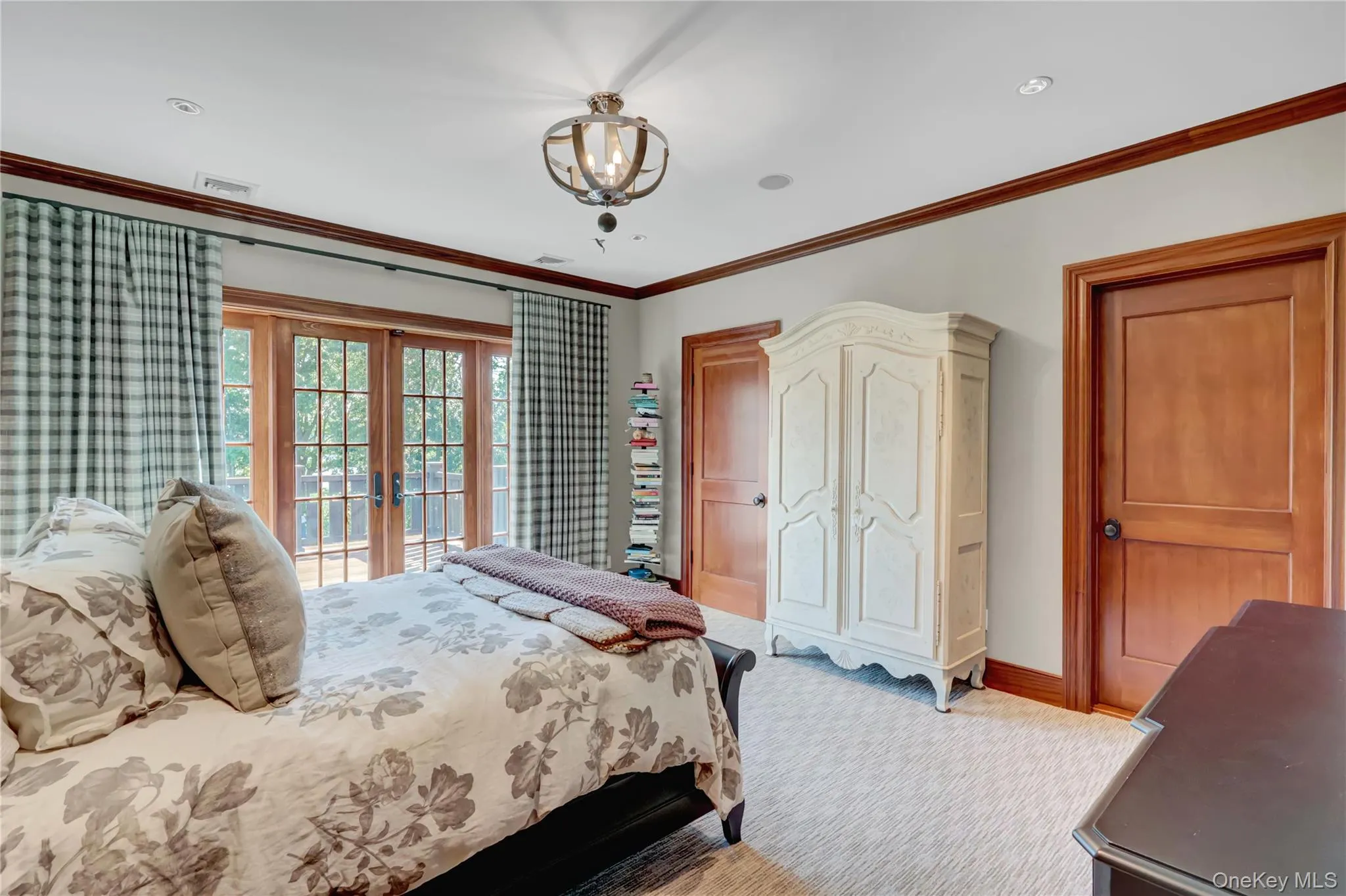 Carpeted bedroom featuring french doors, access to outside, and crown molding Carpeted bedroom featuring french doors, access to outside, and crown molding