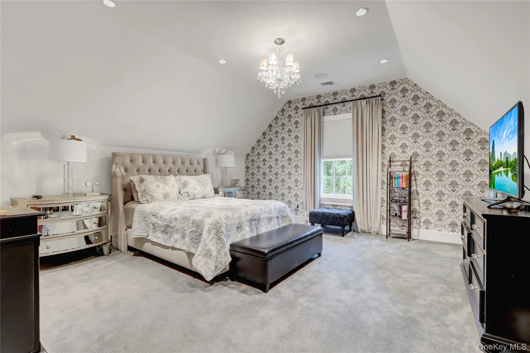 Carpeted bedroom with a chandelier, vaulted ceiling, and recessed lighting Carpeted bedroom with a chandelier, vaulted ceiling, and recessed lighting