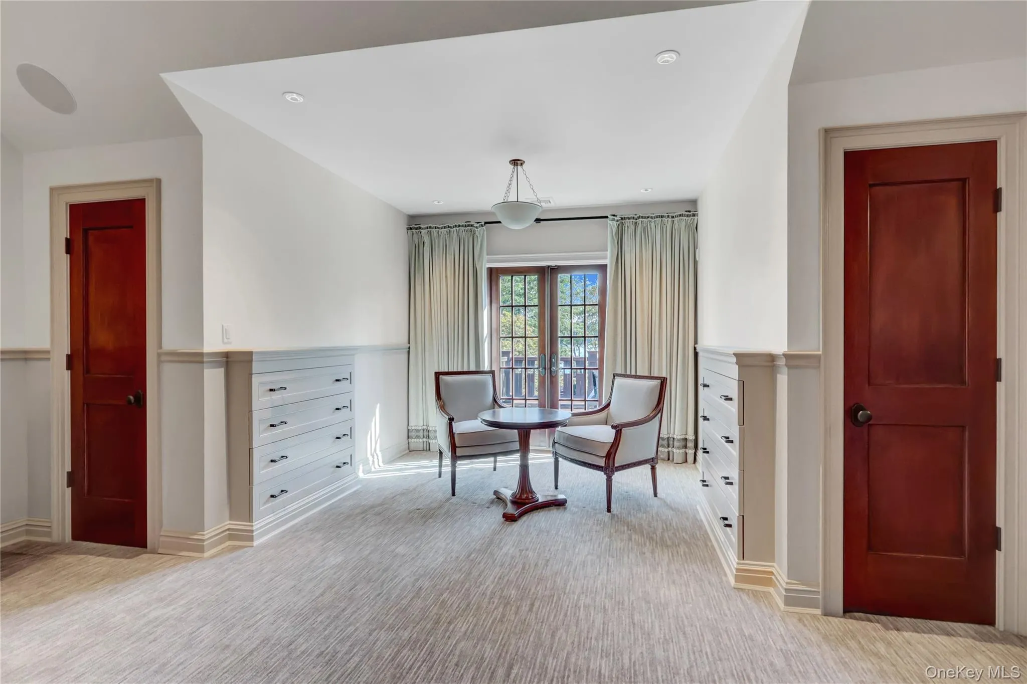 Sitting room with light colored carpet and baseboards Sitting room with light colored carpet and baseboards