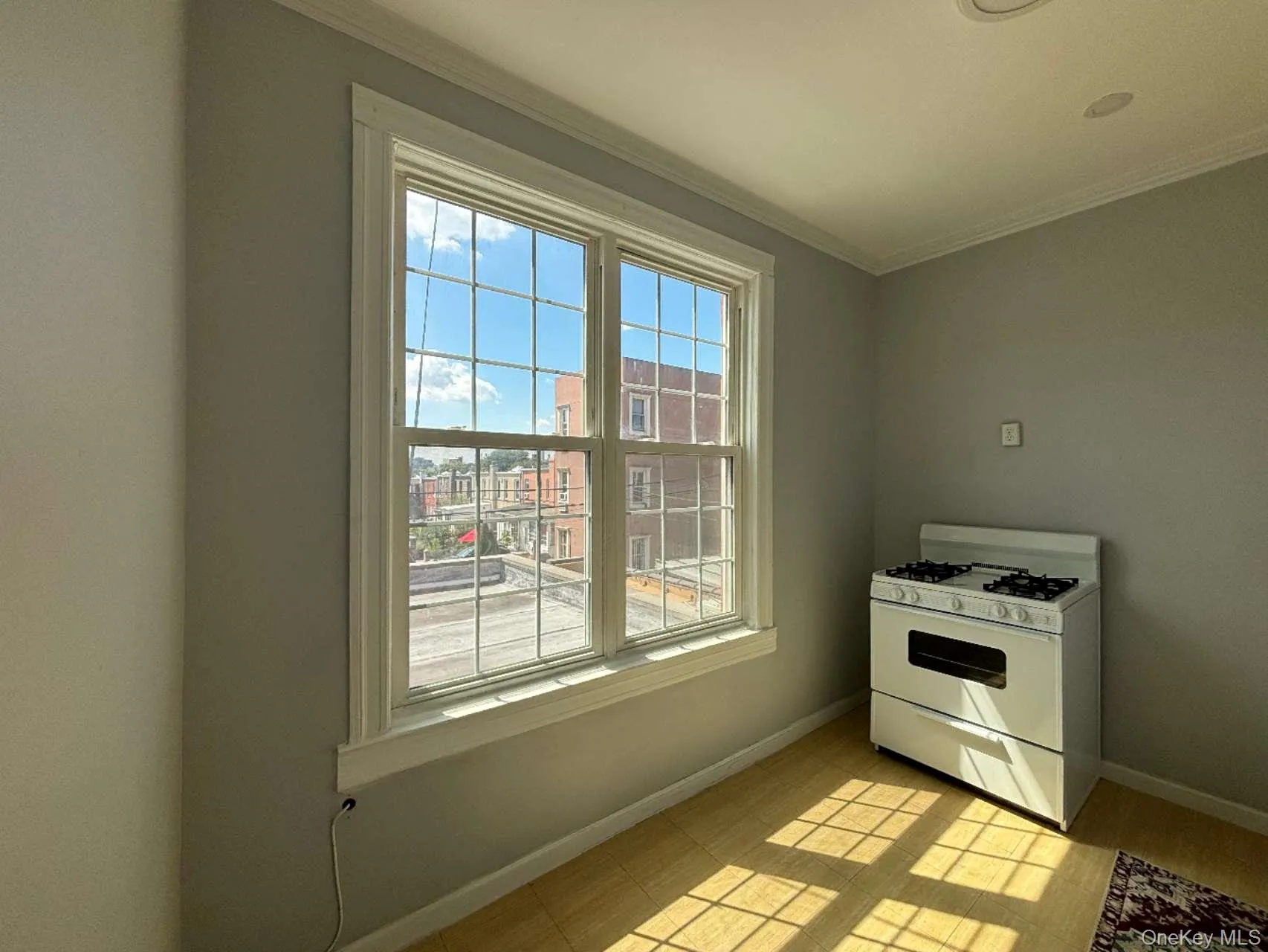 Kitchen featuring white range with gas stovetop and crown molding Kitchen featuring white range with gas stovetop and crown molding