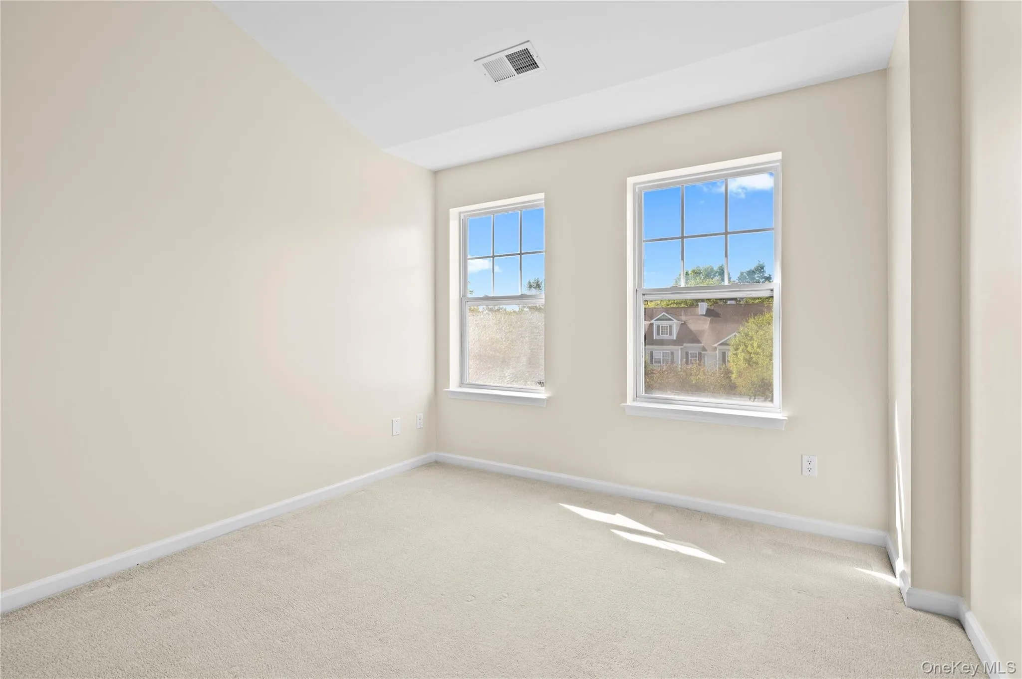 second bedroom with light carpet and a closet second bedroom with light carpet and a closet