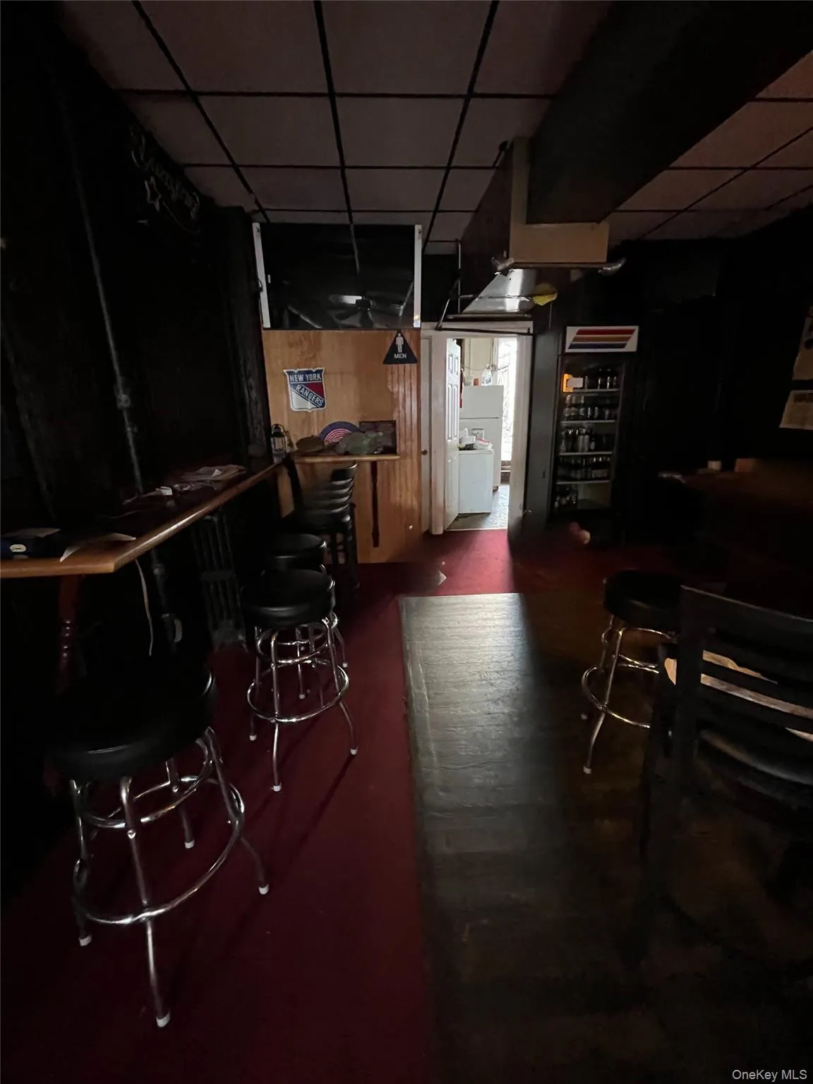 Bar featuring a drop ceiling Bar featuring a drop ceiling
