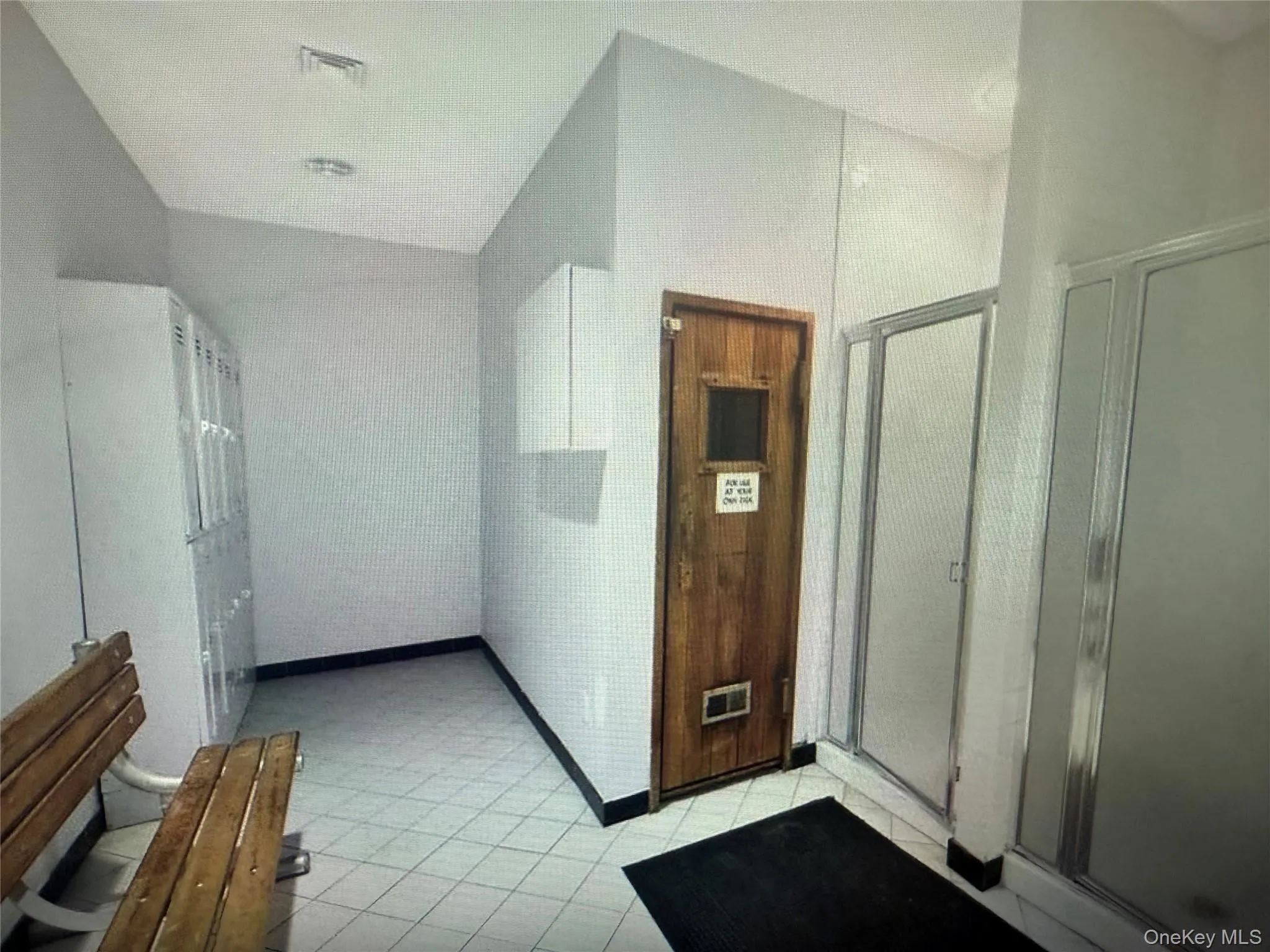 Bathroom with a shower stall, vaulted ceiling, and light tile patterned flooring Bathroom with a shower stall, vaulted ceiling, and light tile patterned flooring