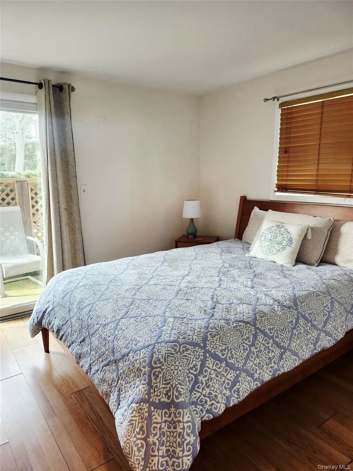 Bedroom with hardwood / wood-style flooring and access to outside Bedroom with hardwood / wood-style flooring and access to outside