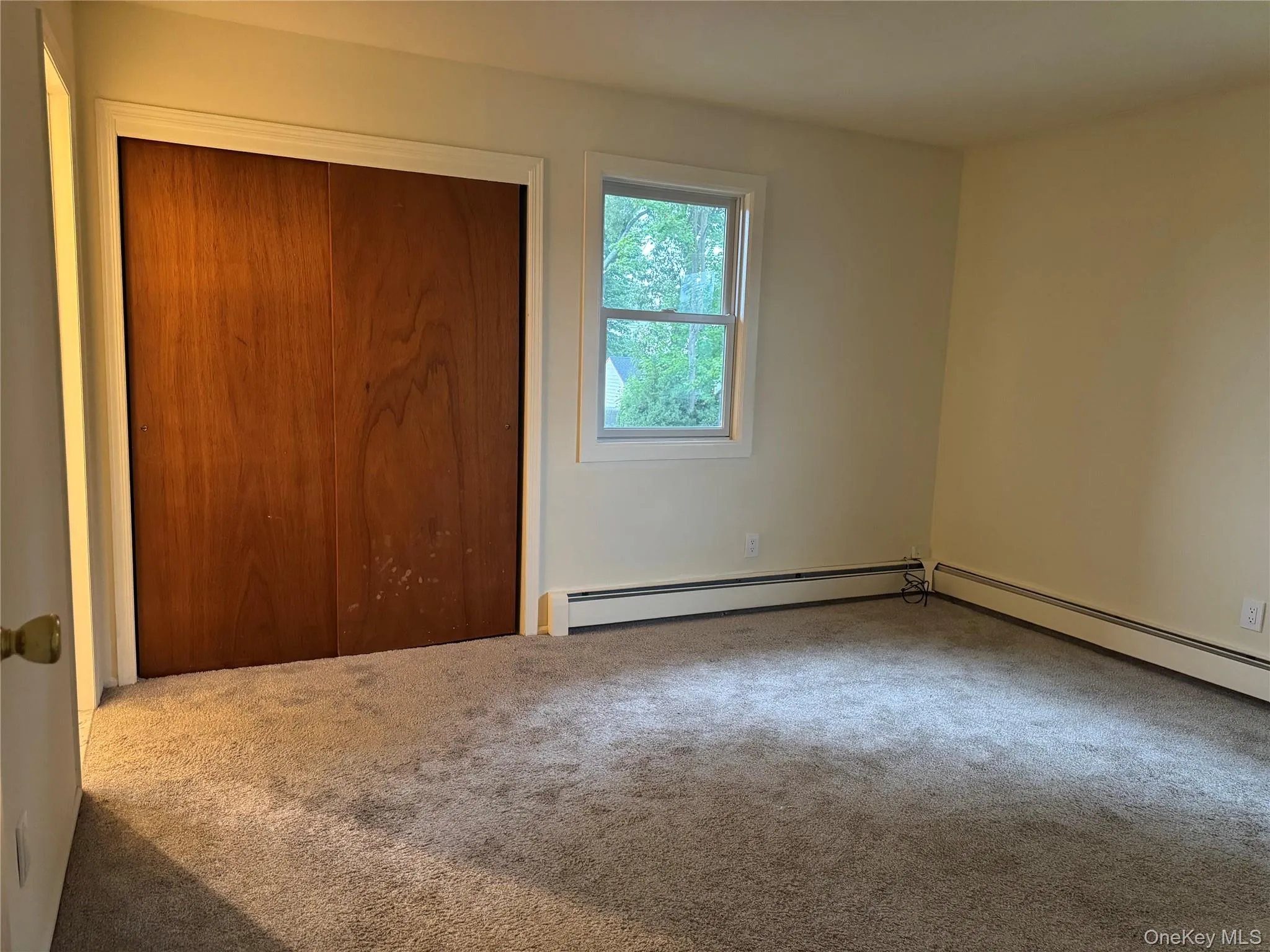 Unfurnished bedroom featuring carpet floors and a closet Unfurnished bedroom featuring carpet floors and a closet