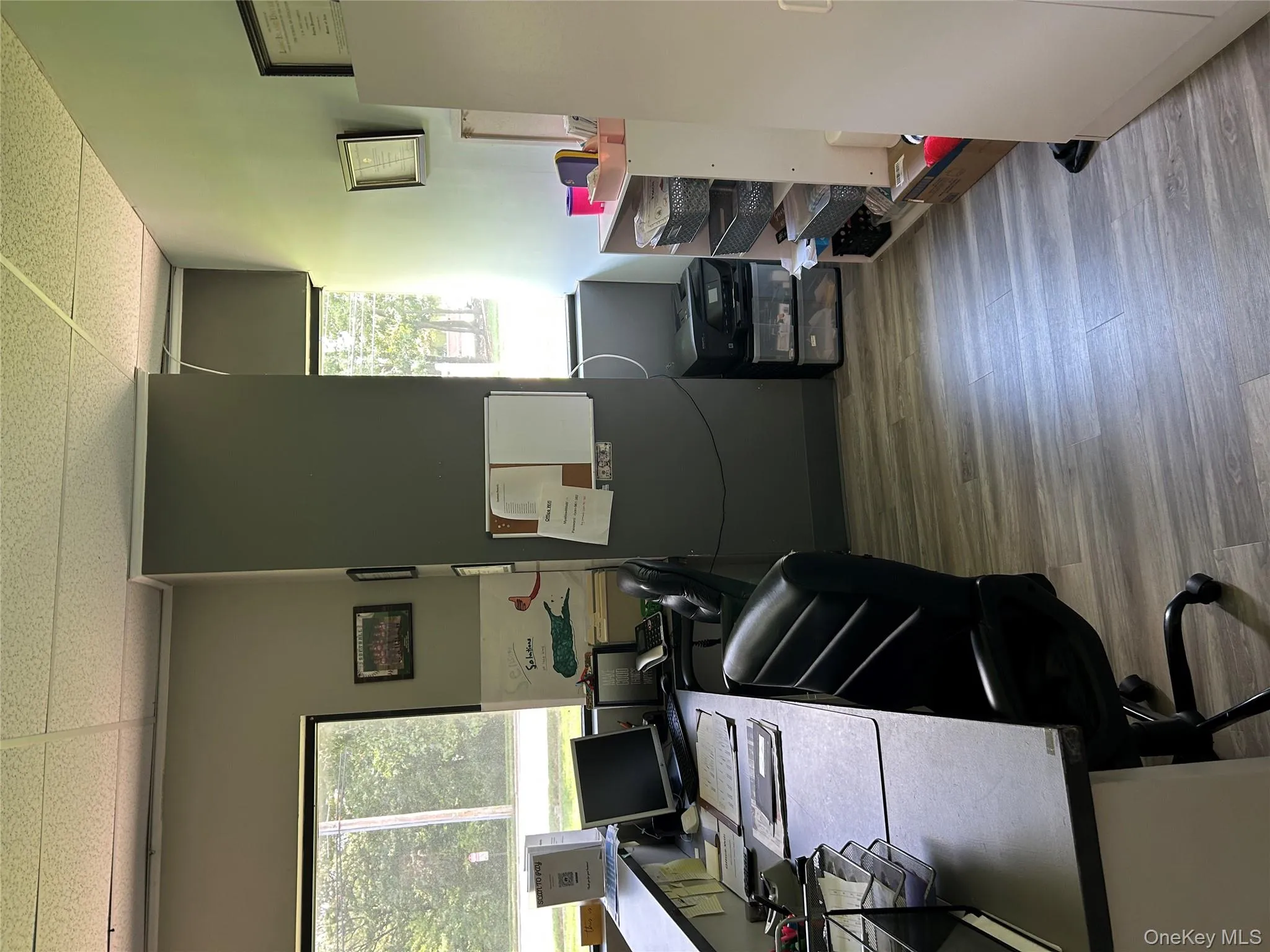 Office featuring light wood-style floors and a drop ceiling Office featuring light wood-style floors and a drop ceiling