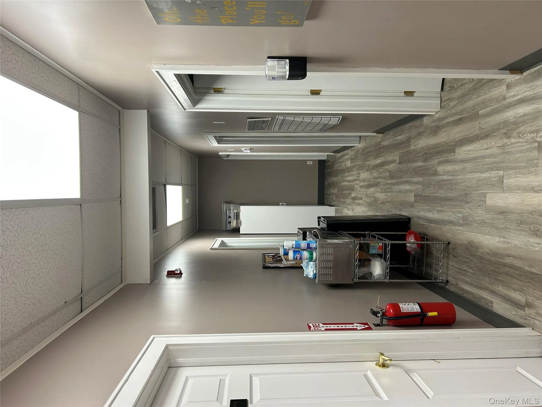 Corridor with a drop ceiling and light wood-type flooring Corridor with a drop ceiling and light wood-type flooring