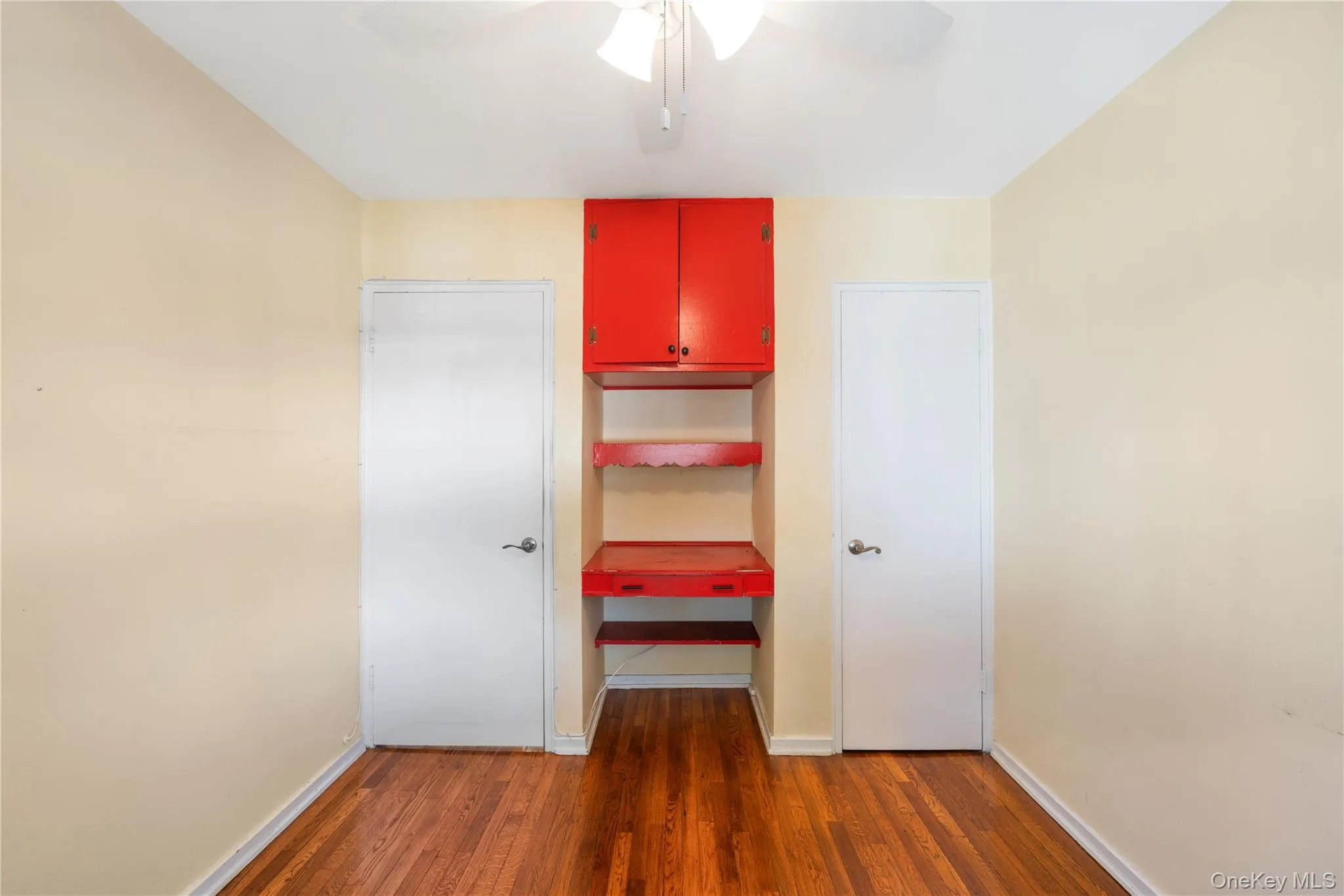Unfurnished bedroom with dark wood finished floors and ceiling fan Unfurnished bedroom with dark wood finished floors and ceiling fan
