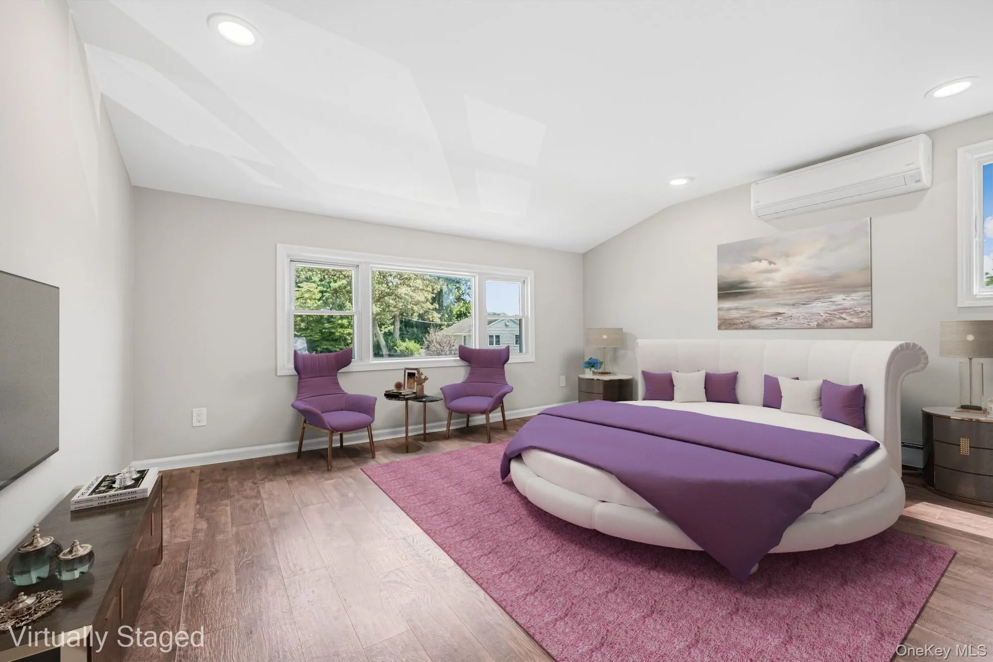 Bedroom featuring recessed lighting, a wall mounted air conditioner, and wood finished floors Bedroom featuring recessed lighting, a wall mounted air conditioner, and wood finished floors
