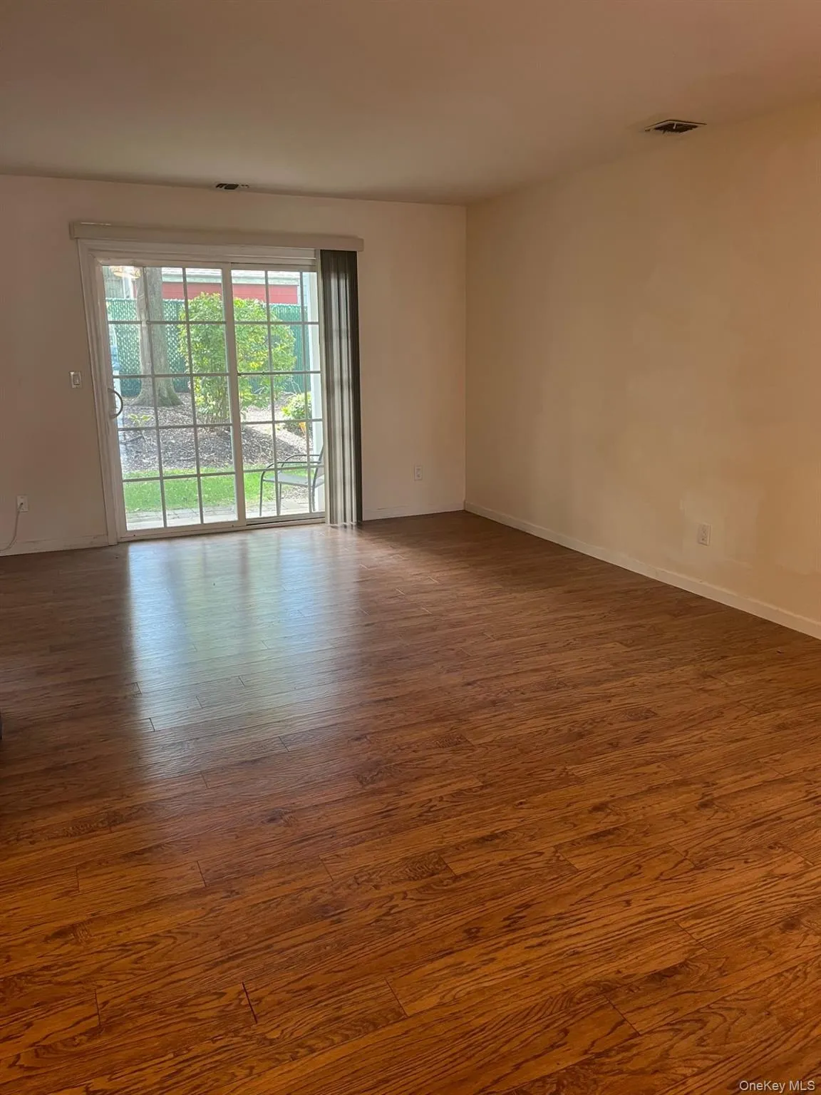 large room with sliders to the pvt backyard  with hardwood  wood floors large room with sliders to the pvt backyard  with hardwood  wood floors