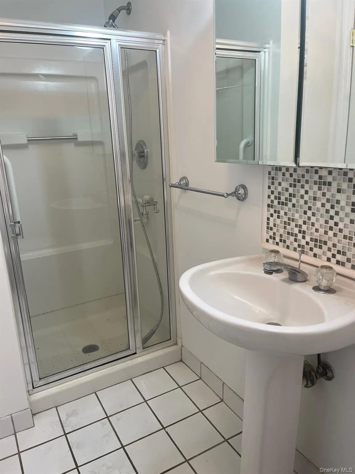 Full bath with light tile patterned floors, a shower stall, in the 2nd bedroom/office Full bath with light tile patterned floors, a shower stall, in the 2nd bedroom/office