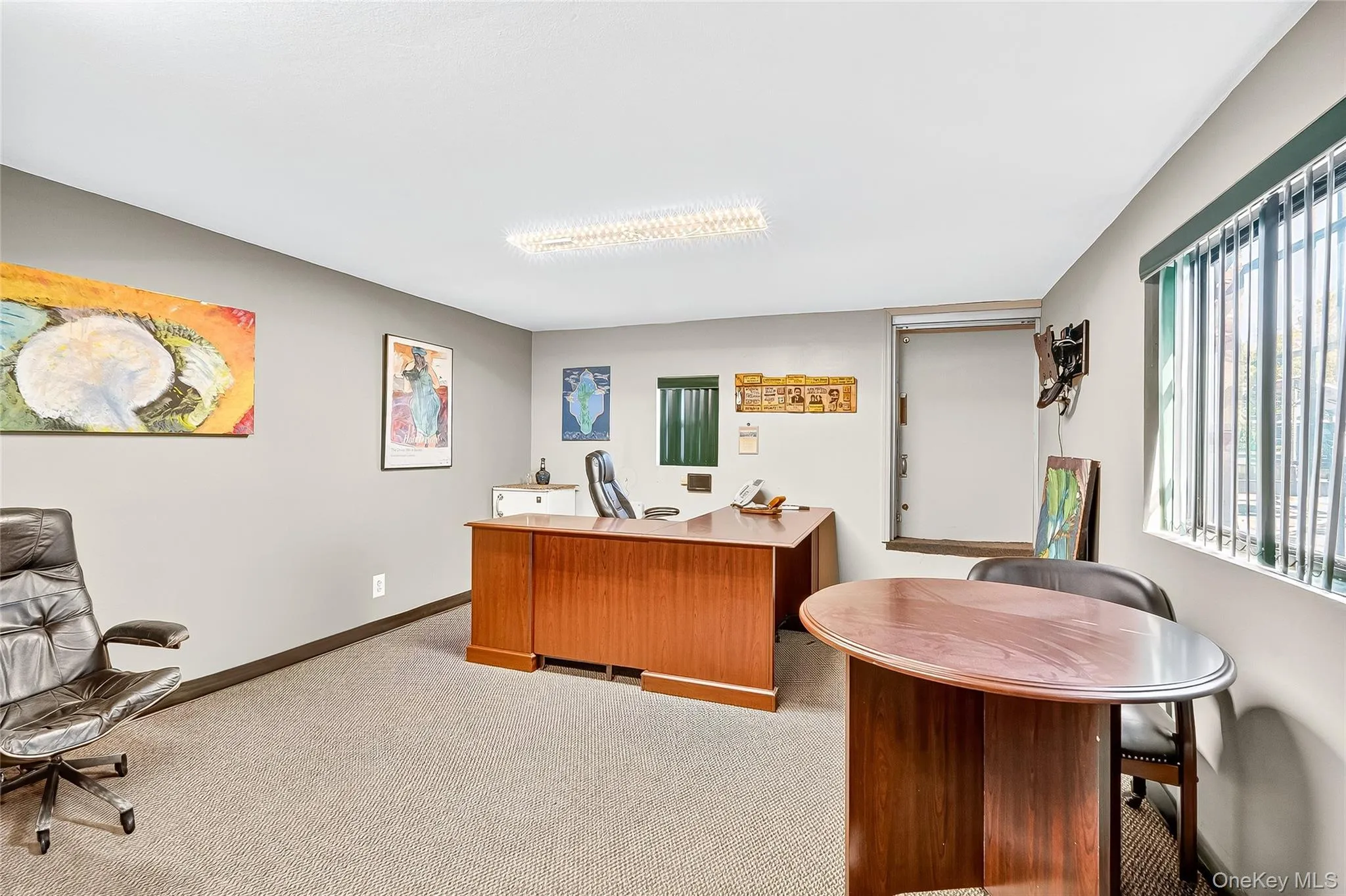 Home office with baseboards and light carpet Home office with baseboards and light carpet