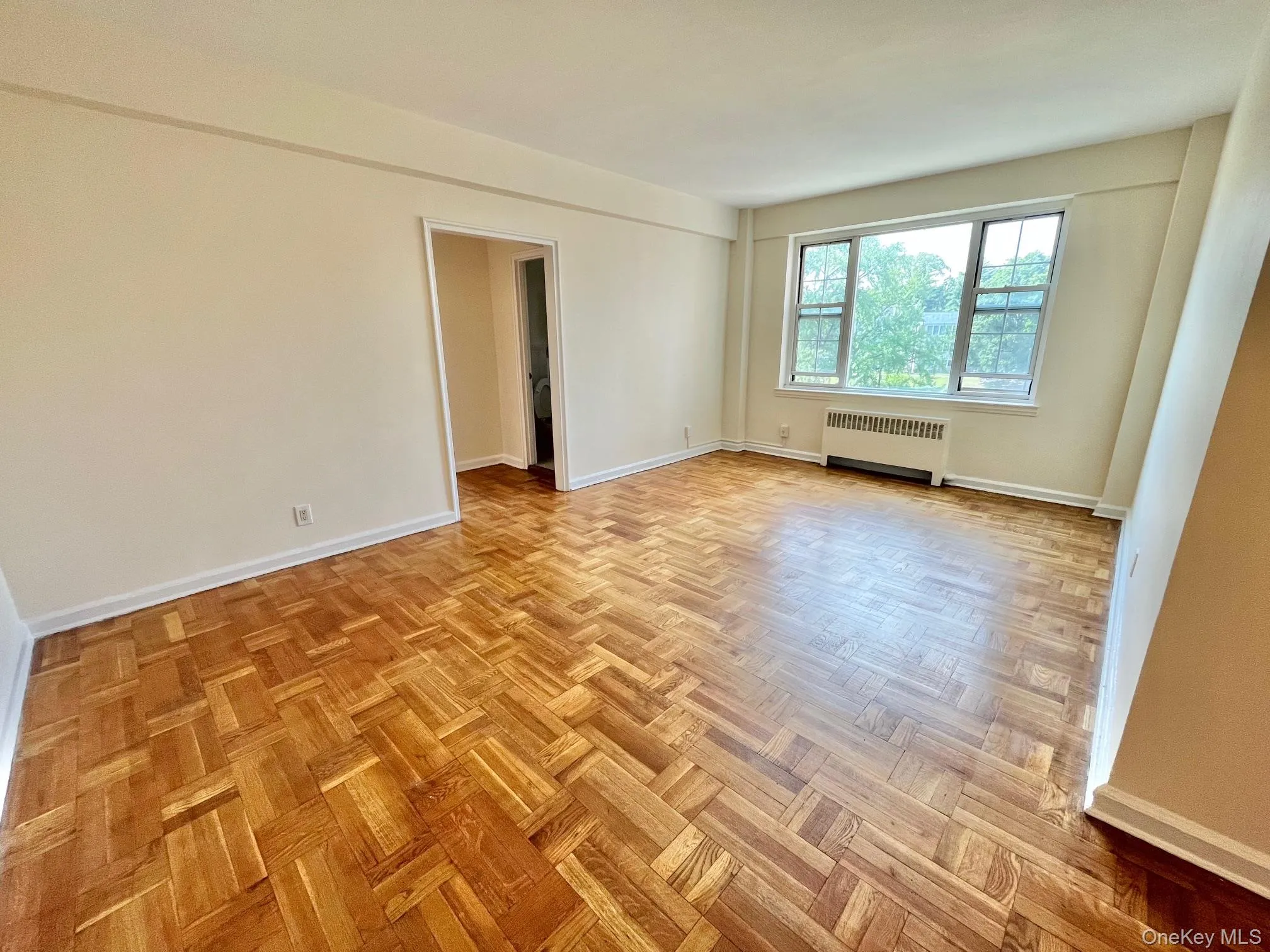Unfurnished room with baseboards and radiator Unfurnished room with baseboards and radiator