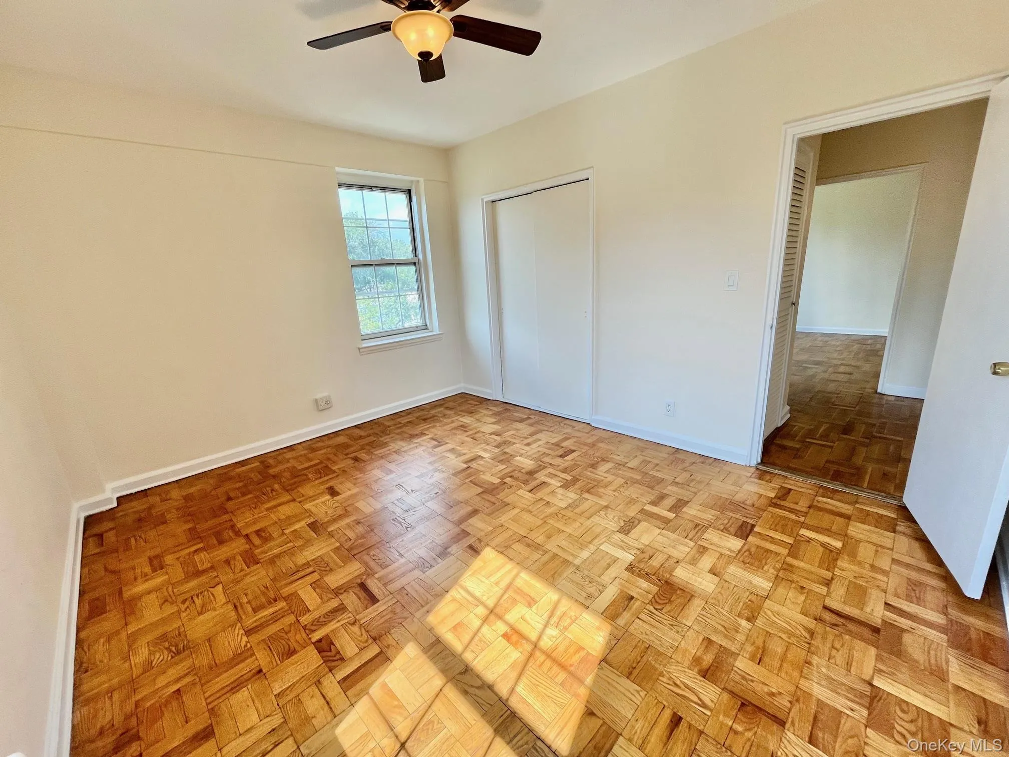 Unfurnished bedroom with ceiling fan and a closet Unfurnished bedroom with ceiling fan and a closet