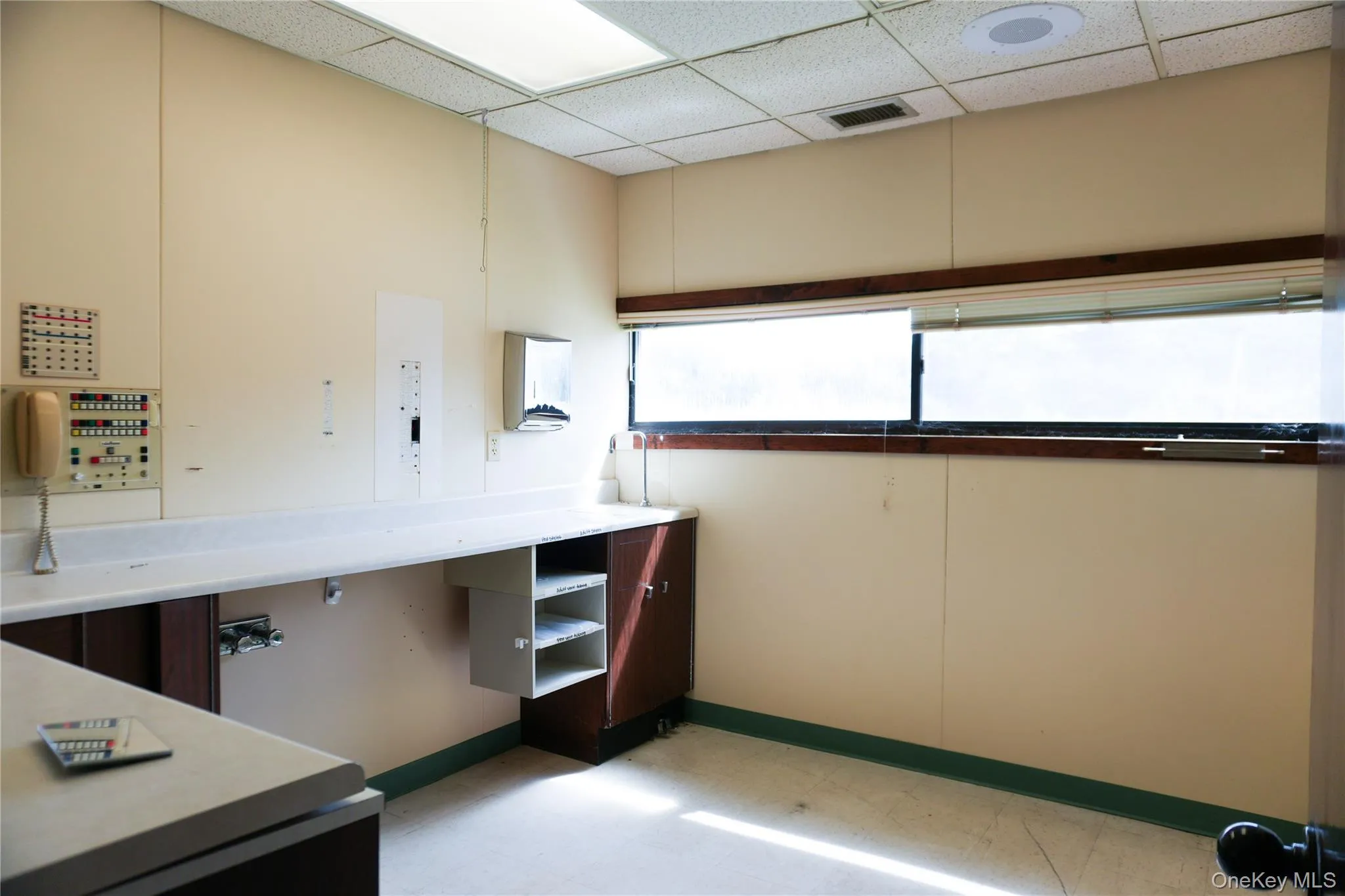 Unfurnished office featuring light floors and a drop ceiling Unfurnished office featuring light floors and a drop ceiling