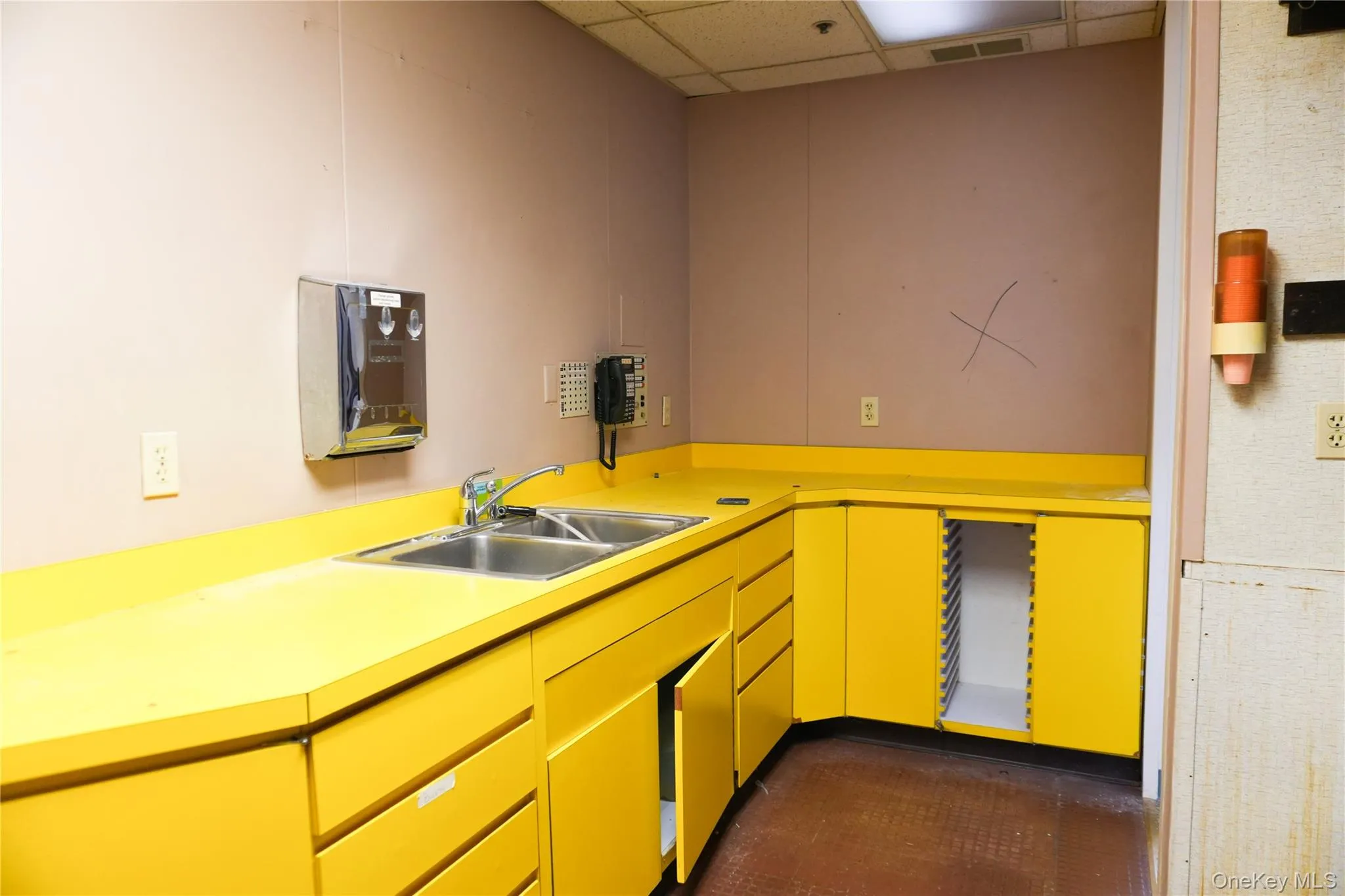 Kitchen with a drop ceiling and light countertops Kitchen with a drop ceiling and light countertops