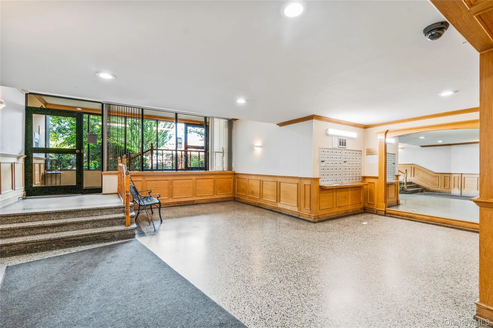 Lobby featuring wainscoting, a decorative wall, and recessed lighting Lobby featuring wainscoting, a decorative wall, and recessed lighting
