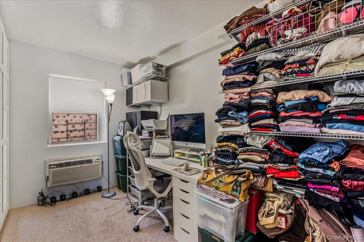Office space with light carpet and a wall unit AC Office space with light carpet and a wall unit AC
