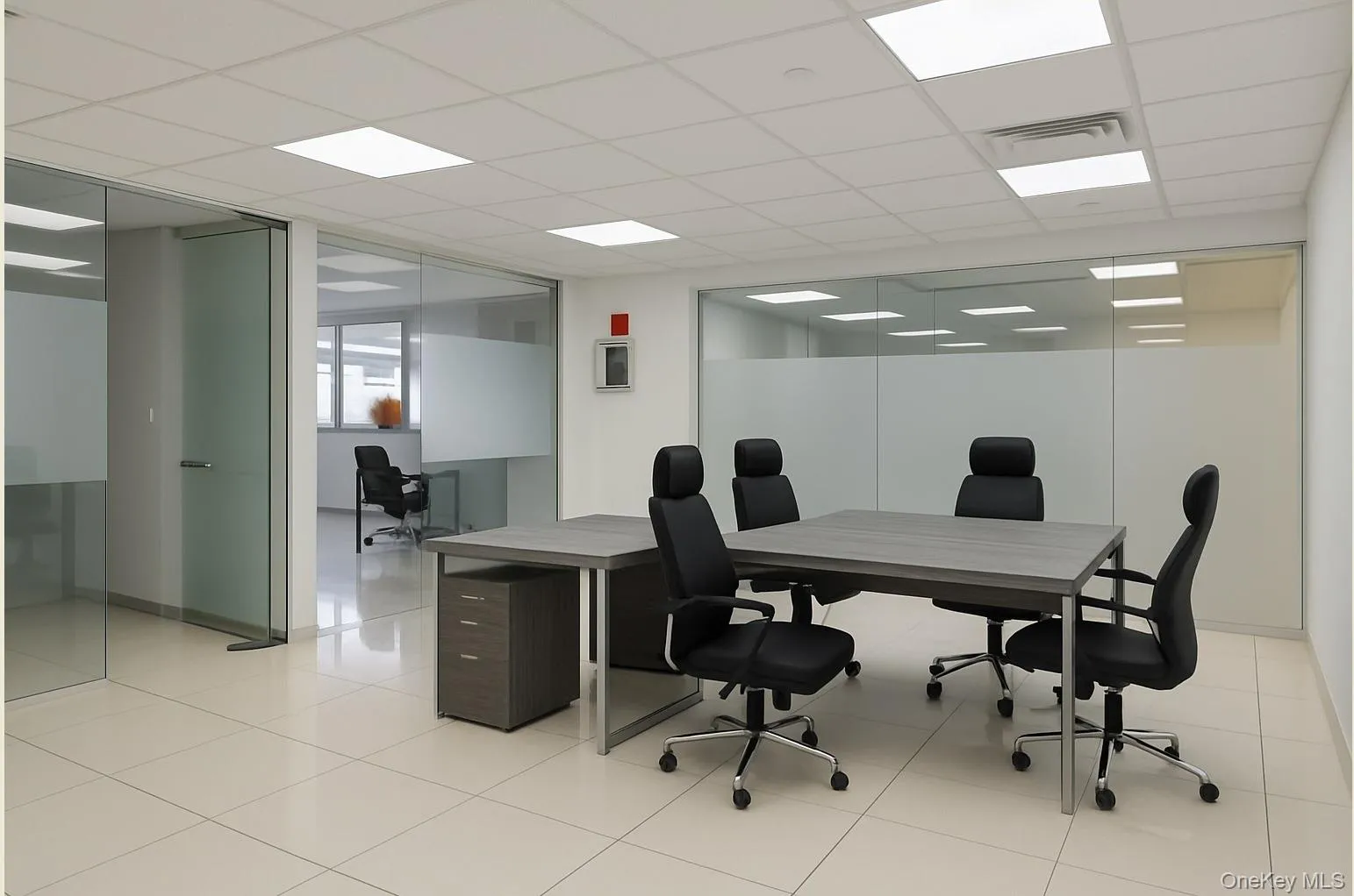 Office area featuring a paneled ceiling and light tile patterned floors Office area featuring a paneled ceiling and light tile patterned floors