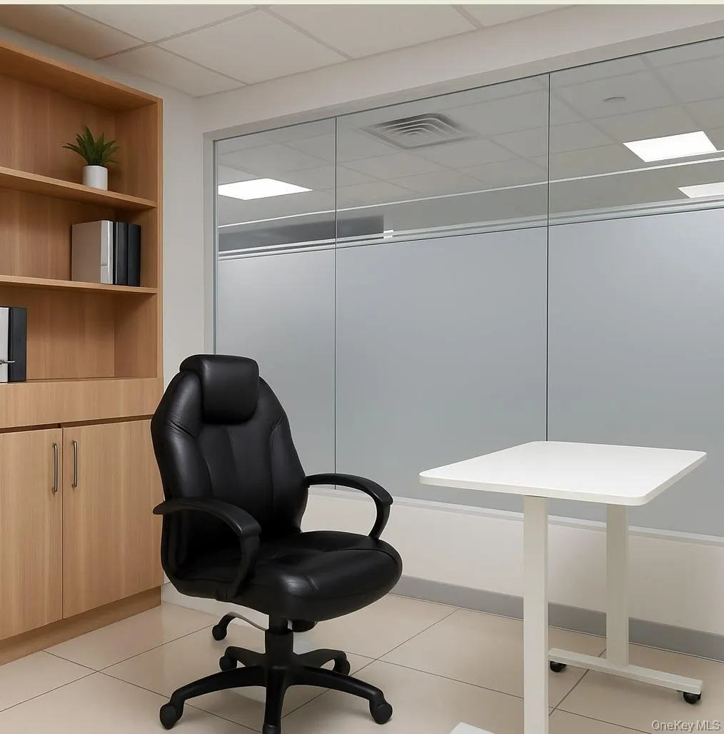 Office featuring light tile patterned floors and a paneled ceiling Office featuring light tile patterned floors and a paneled ceiling